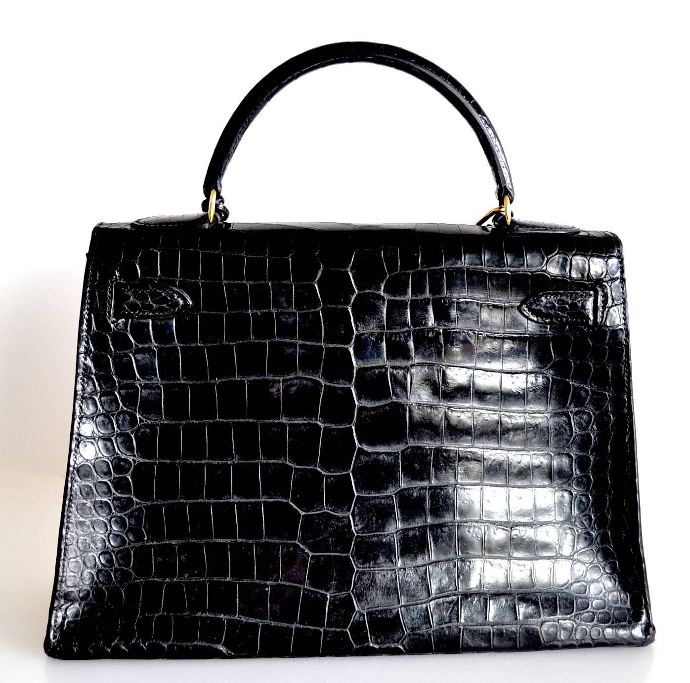 Hermes Kelly 32 Black Crocodile
 
Black shiny crocodile skin with gold hardware
Sellier model
 
The bag is lined with chevre leather. Interior is in good condition with a pocket.
This bag is in good condition. It is a vintage bag from 70s.