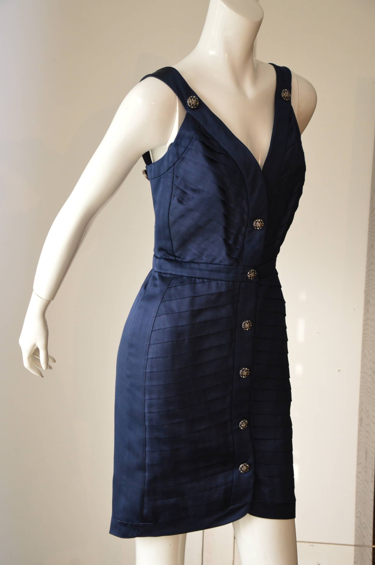 Chanel, beautiful navy blue silk satin dress, the satin gives the effect of color change in the fabric from dark blue too lighter blue, front and back patinated silver buttons, dress with pleated front effect, sides and back flat silk satin, fully
