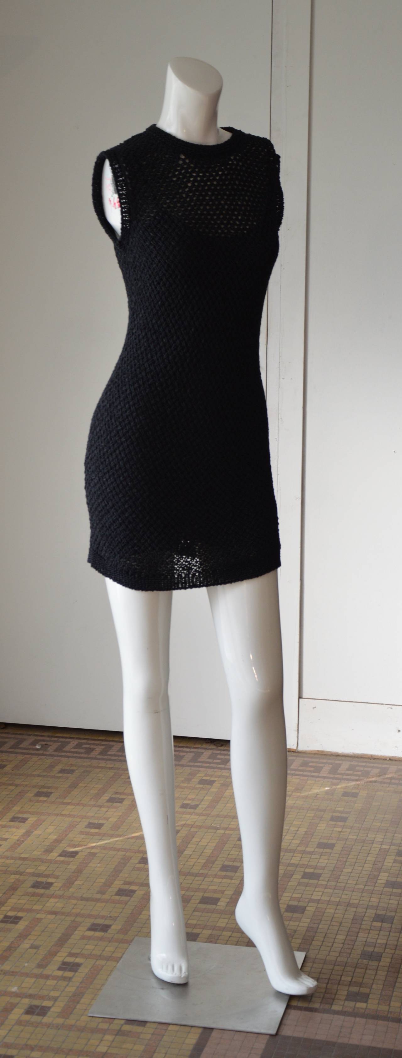 Late 1980s early 1990s this little back crochet knit dress is really perfect both as a dress or a tunic. The under dress is made of black chiffon silk.