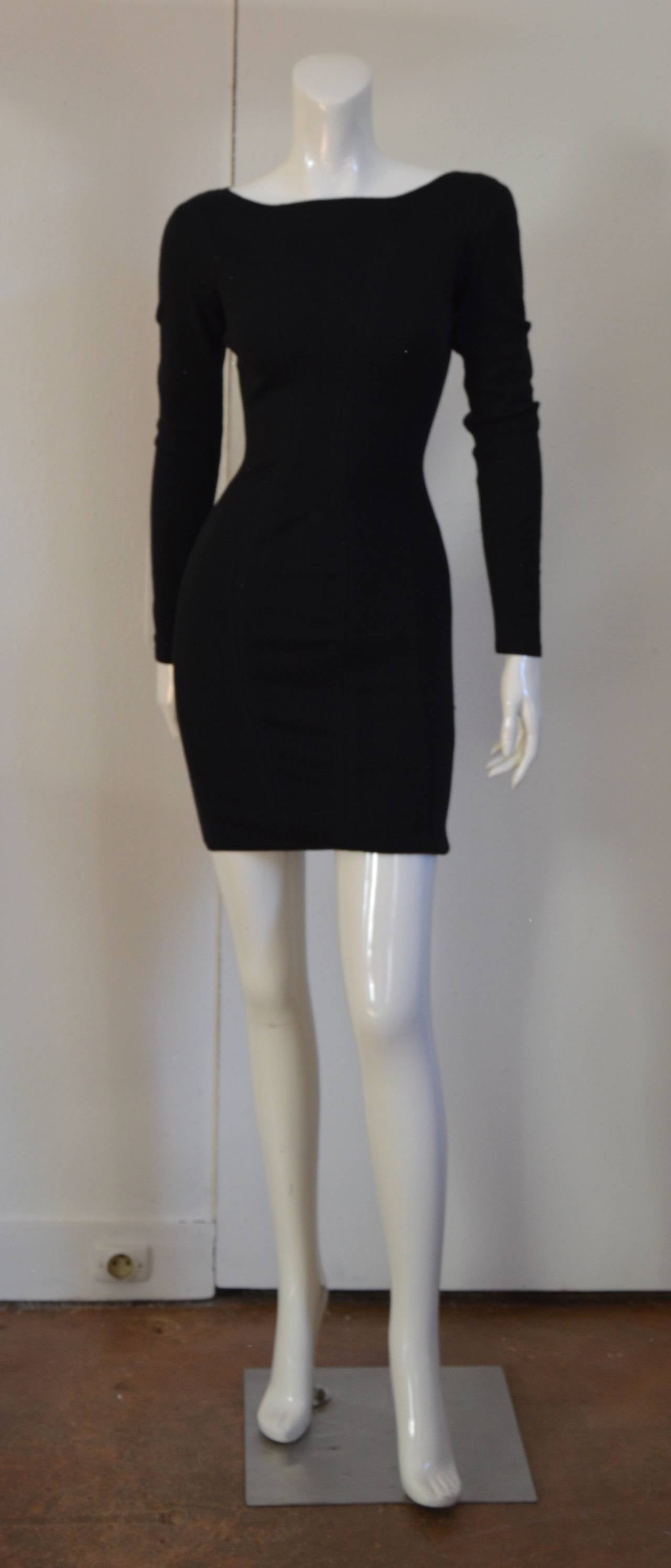 Kashmir, Wool and Viscose Jet black long sleeved mini dress designed by Azzedine Alaia dating to 1990. Labeled a size XS, although this can easily fit a size small as well. Zips up center back. Excellent condition.