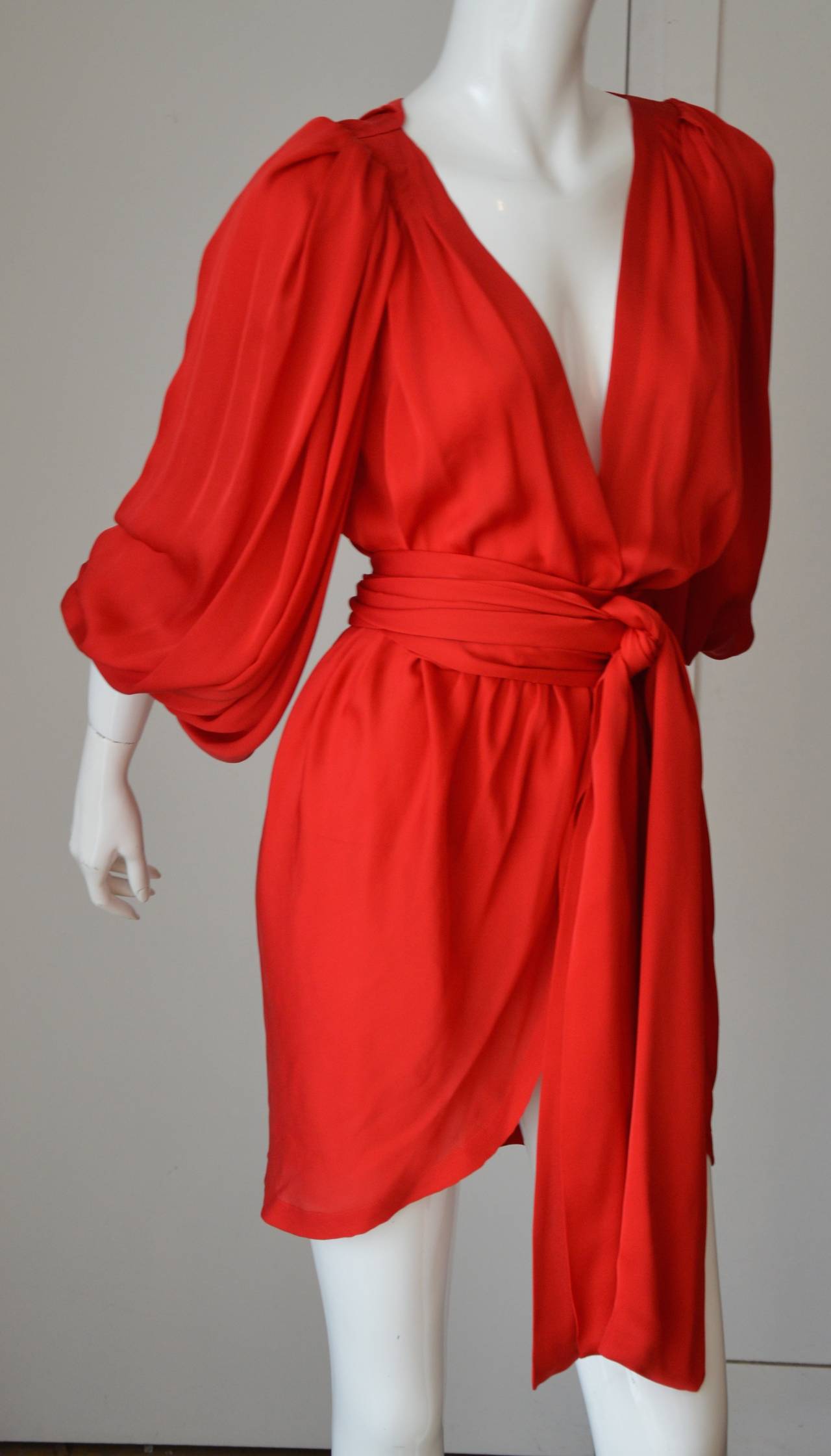 This Yves Saint Laurent cocktail or diner dress is so soft, it's weight so light and it's color so fantastic that you can only adore it. 
Mr Saint Laurent was known for loving wrap cocktail dresses in silk, satin, silk chiffon.