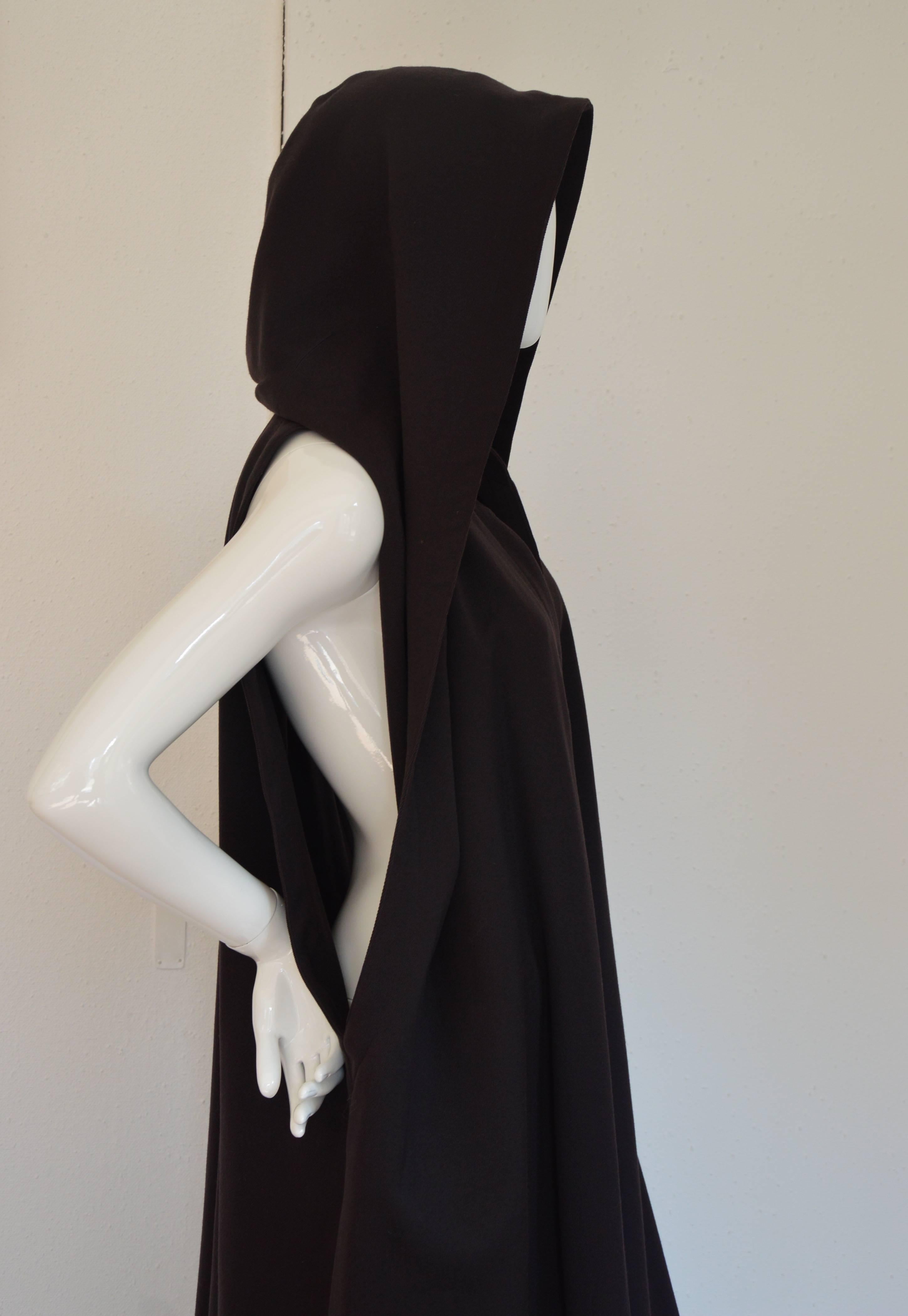 Wool dark brown Alaia longue cape or overcoat with large collar that can be wear as a hood, or on the shoulders and even as a puffy structured neck line. 
2 Large cutouts on both sides that can be shown or hide, adding to the magic of Alaia's