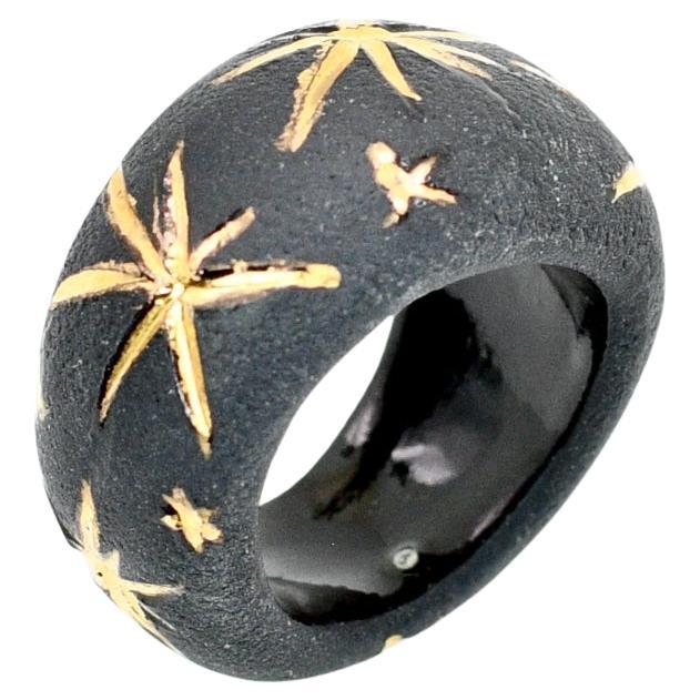 Porcelain  24K gold embellishment  Handmade in London

Indulge in luxury with the CAPELLA Black Porcelain Ring. Crafted from exquisite black onyx porcelain, its matte velvety surface harmoniously contrasts with the elegant shine of golden stars,