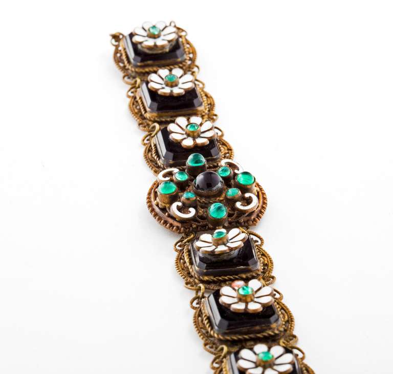 Fabulous Austro Hungarian Enamel, Onyx and Glass Cabochon bracelet with
enamel flowers sitting on top of onyx in a gold filigree bracelet.  Unsigned.  Exceptional period piece despite early repairs.