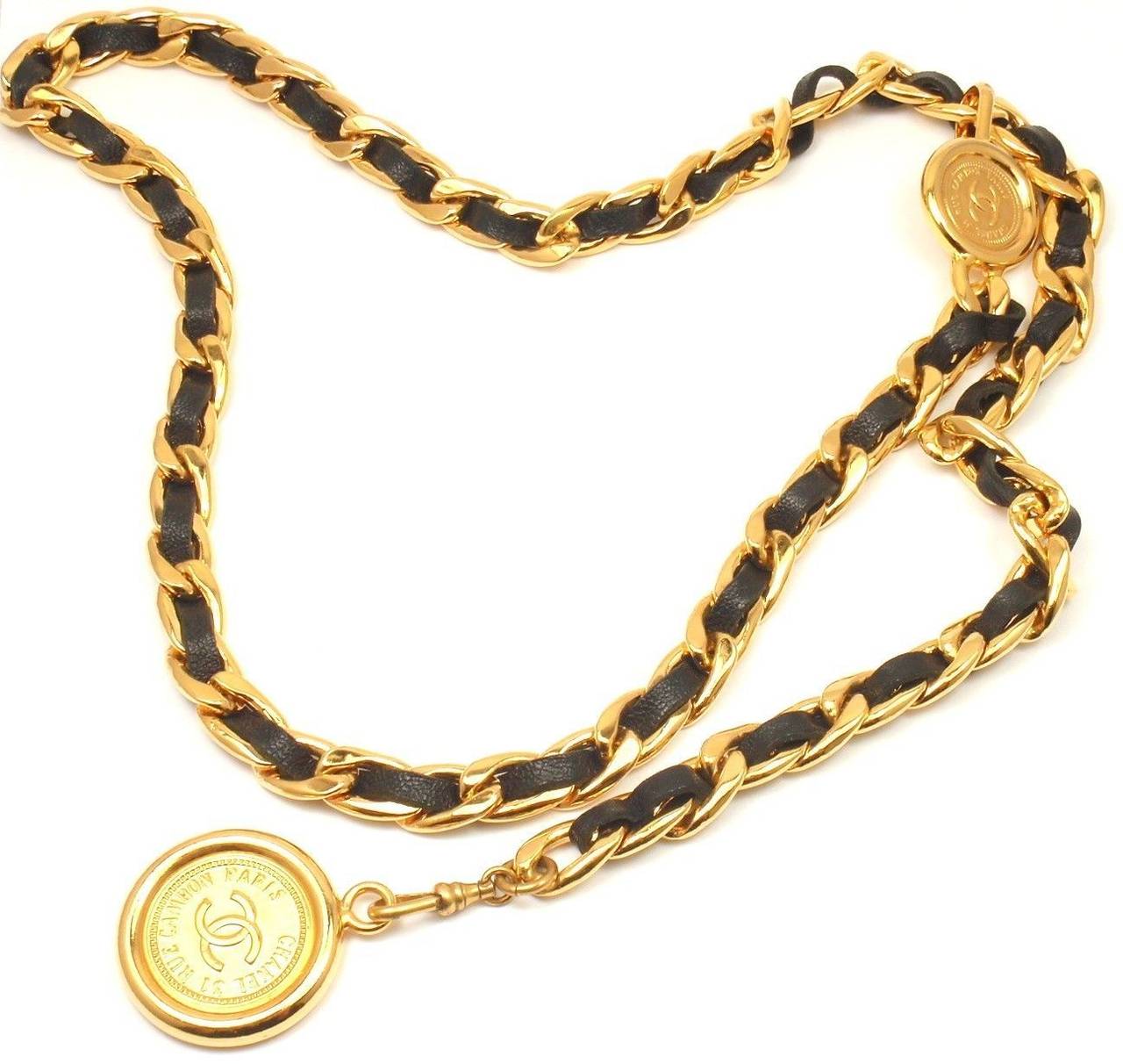 Vintage French Couture Collection Gold Tone Black Leather Signature Long Necklace or Belt from CHANEL. 

Length: 36