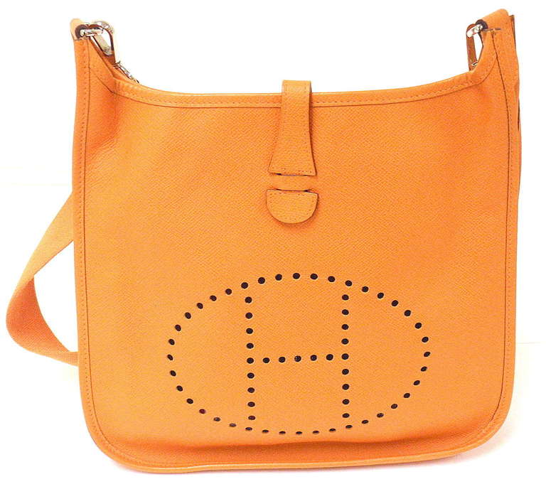 HERMES EVELYNE PM ORANGE EPSOM LEATHER SHW SHOULDER BAG, 2006

Comes with dustbag.
 This bag is in EXCELLENT condition. Features sturdy epsom leather exterior with sueded leather interior. Orange strap.

Hard to capture the beauty of the