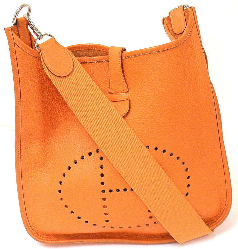 HERMES EVELYNE GM ORANGE CLEMENCE LEATHER SHW SHOULDER BAG, 2002

Please note, color can vary greatly from monitor to monitor. This hue is the signature Hermes orange.

This bag is in GREAT condition.

Exterior:
Scratches: No scratches. Pen