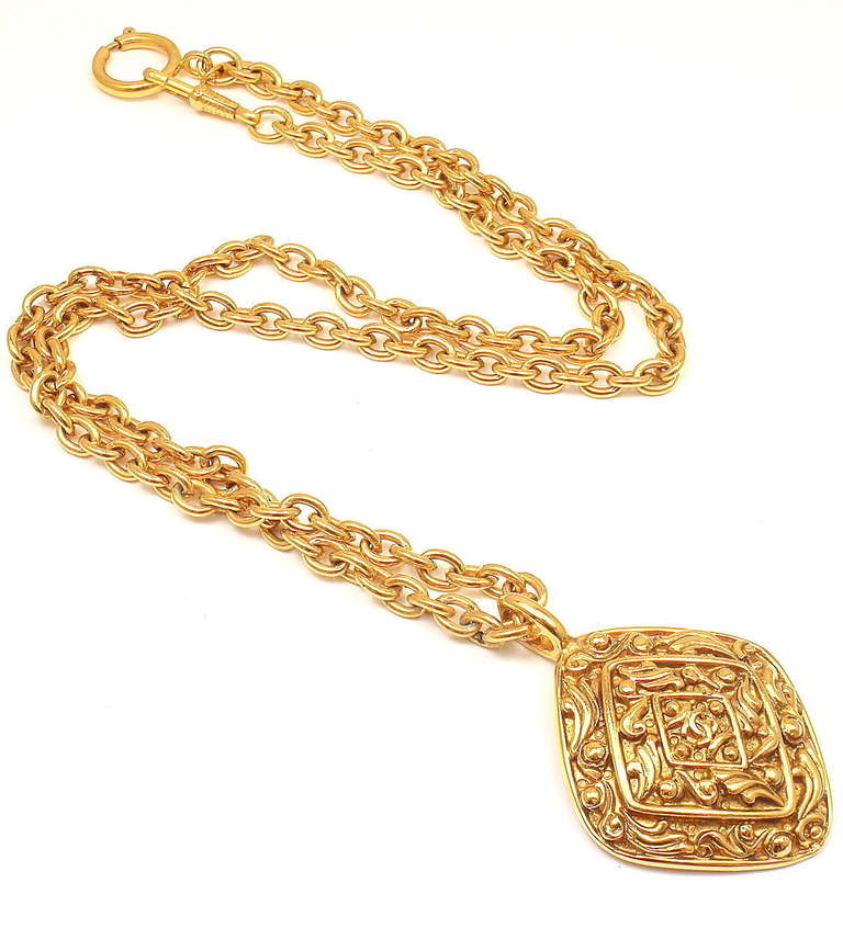 Vintage Gold Tone Long Textured Amulet Logo Necklace from CHANEL. 

Measurements: 5mm chain, 2.3 x 1.6 inch pendant pendant, 29'' long
Weight: 72.1 grams
Stamped Hallmarks: Chanel Made in France tag and stamped on back of pendant

*Free
