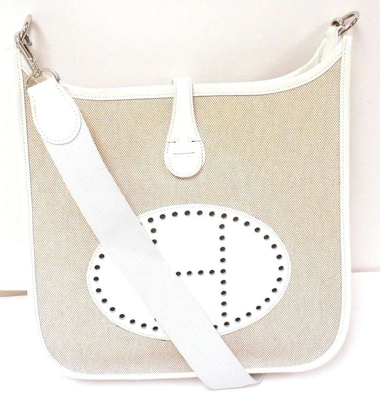 HERMES EVELYNE PM CREAM EPSOM LEATHER CANVAS SHW SHOULDER BAG, 2004

 This bag is in GREAT condition. Features thick , sturdy epsom leather panels on sides with canvas front and back, with canvas interior and leather pocket. 

Color will vary