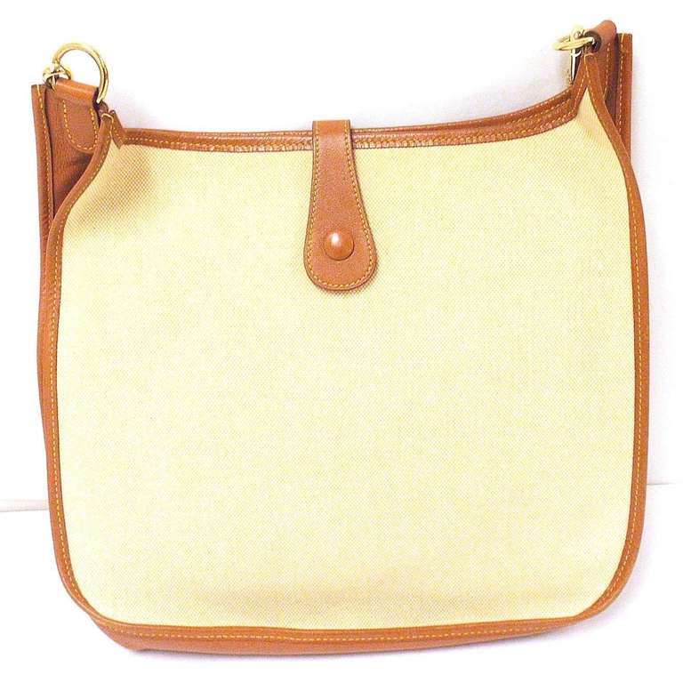 HERMES EVELYNE GM TWO TONE TAN COURCHEVEL LEATHER CANVAS GHW SHOULDER BAG, 1997

 This bag is in GREAT condition. Features soft leather exterior paneling with canvas. Canvas interior. Natural tan courchevel leather accented with a sunny cream