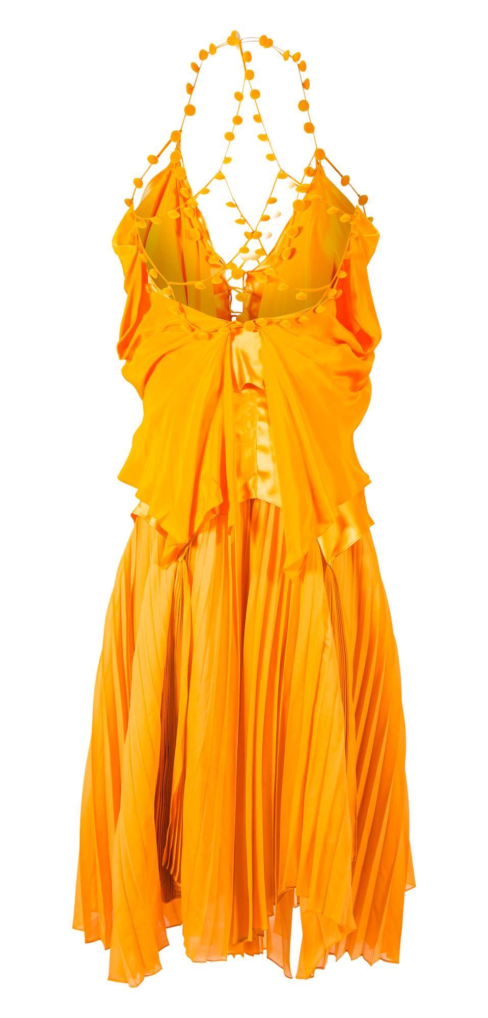 Tom Ford for Yves Saint Laurent at Paris Fashion Week Spring 2004 
Orange silk top and skirt
Top has silk chiffon and silk satin top with velvet buttons
Skirt has long sashes with knife pleats
New without tags - perfect condition
FR38