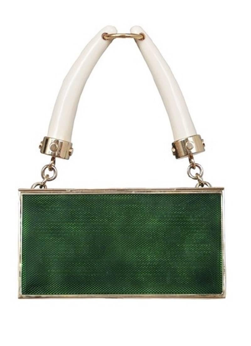 Yves Saint Laurent S/S 2004 RTW Paris Fashion Week
Emerald enamel with gold jewelled stone at front (push down to open)
Gold hardware with YSL engraving
Horn handle
Suede lining