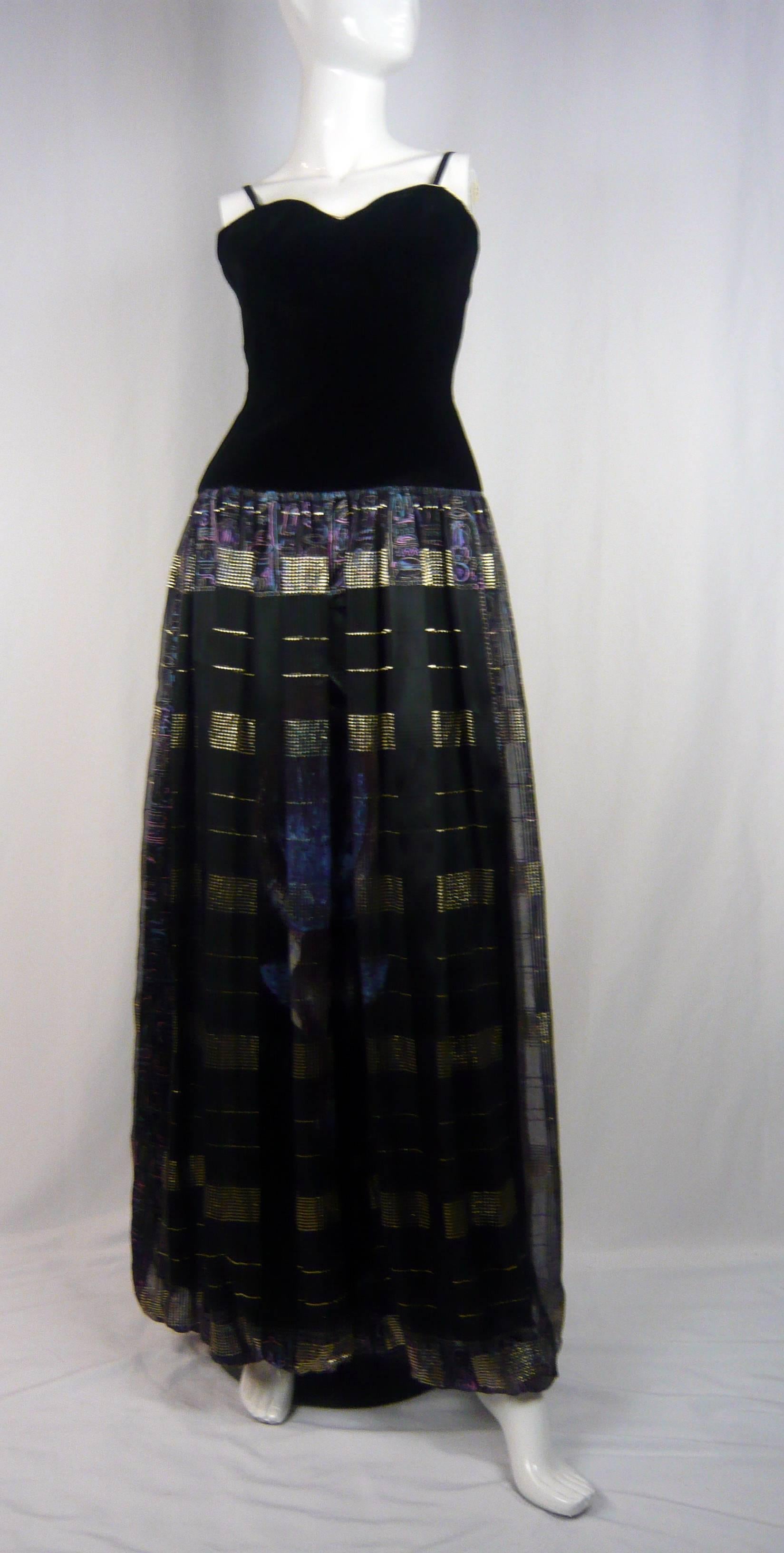 Pierre Balmain RTW 1980s Egyptian Revival evening dress with black velvet bodice attached to a silk egyptian print skirt. 

This gown is  perfectly stunning, Pierre Balmain one of the master french designers of yesteryear whom notably designed for