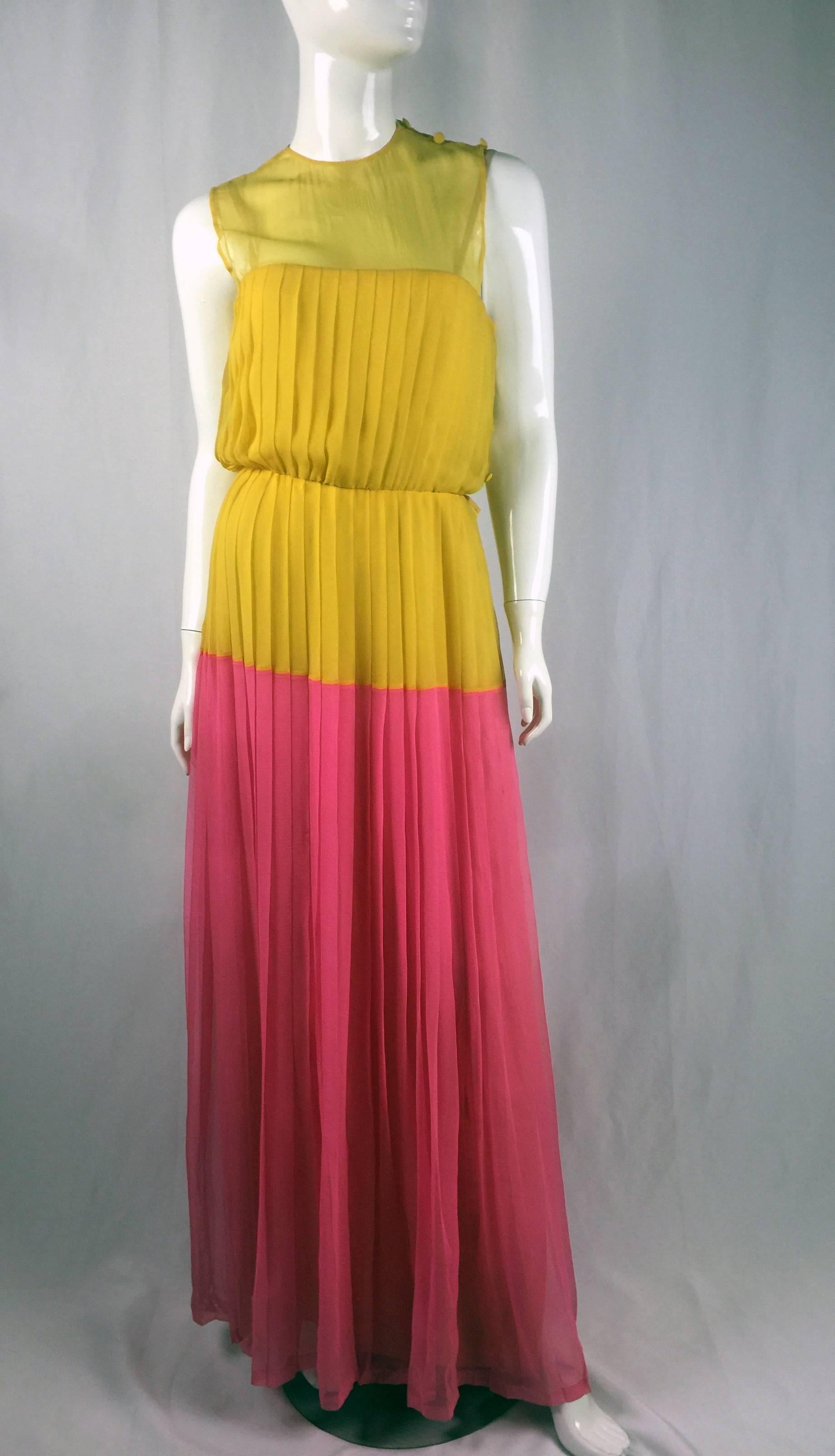 This fabulous 1980s Nina Ricci Silk Chiffon Couture gown is a delicate specialty, Hand Sewn pleating on this gown that cascades to the grown with a fabulous color blocking from yellow to a bright pink. 

The gown also comes with a beautiful yellow