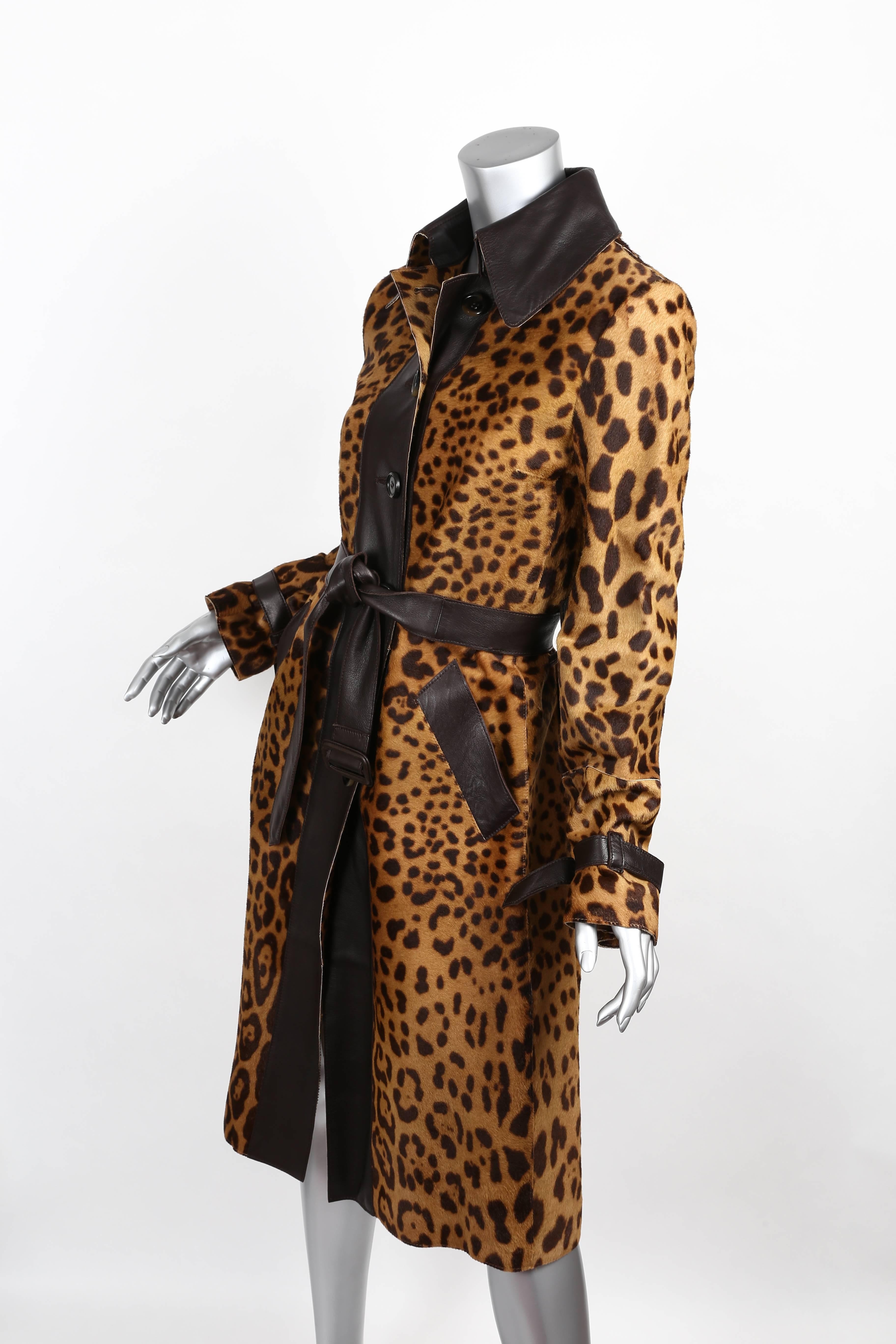Stunning Dolce & Gabbana leopard print pony skin coat with wide brown leather collar, belt and trim. 
Tortoise shell six button closure. 
Silk leopard print lining. 
Condition is excellent.