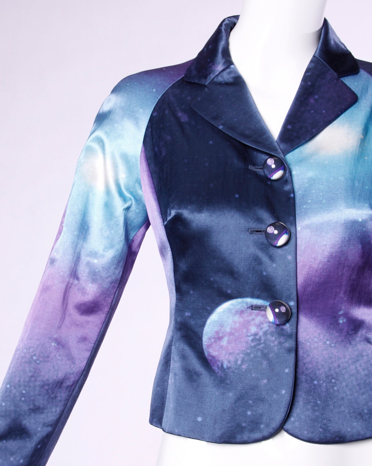 Moschino did it first! Vintage galaxy print jacket in cool tones of blue and purple featuring clear oversized buttons with a moonscape inside. A rare and highly collectible piece!

Details:

Fully Lined
Front Button Closure
Marked Size: I 42/