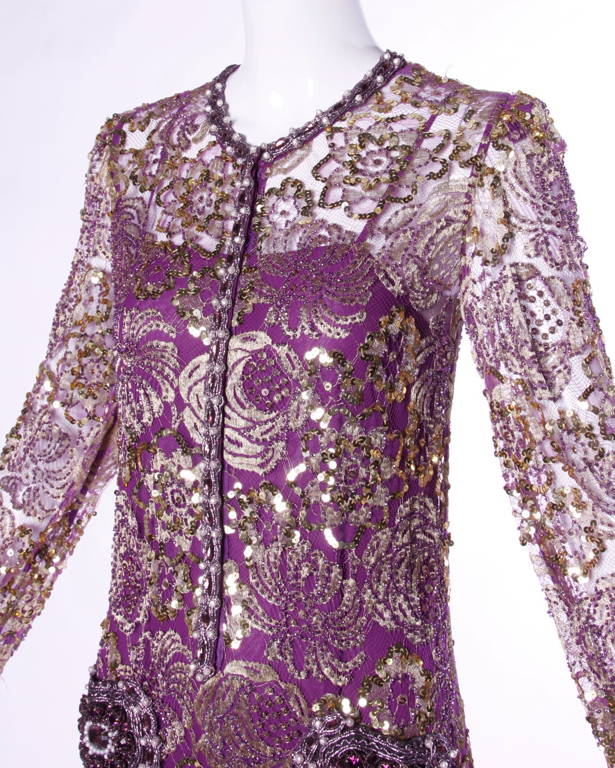 Heavily embellished sheer purple lace cocktail dress with metallic gold sequin and beadwork. Matching silk slip is included to wear underneath the dress.

Details:

Unlined/ Includes Slip
Front Pockets
Dress/ Front Zip and Snap Closure/ Snap