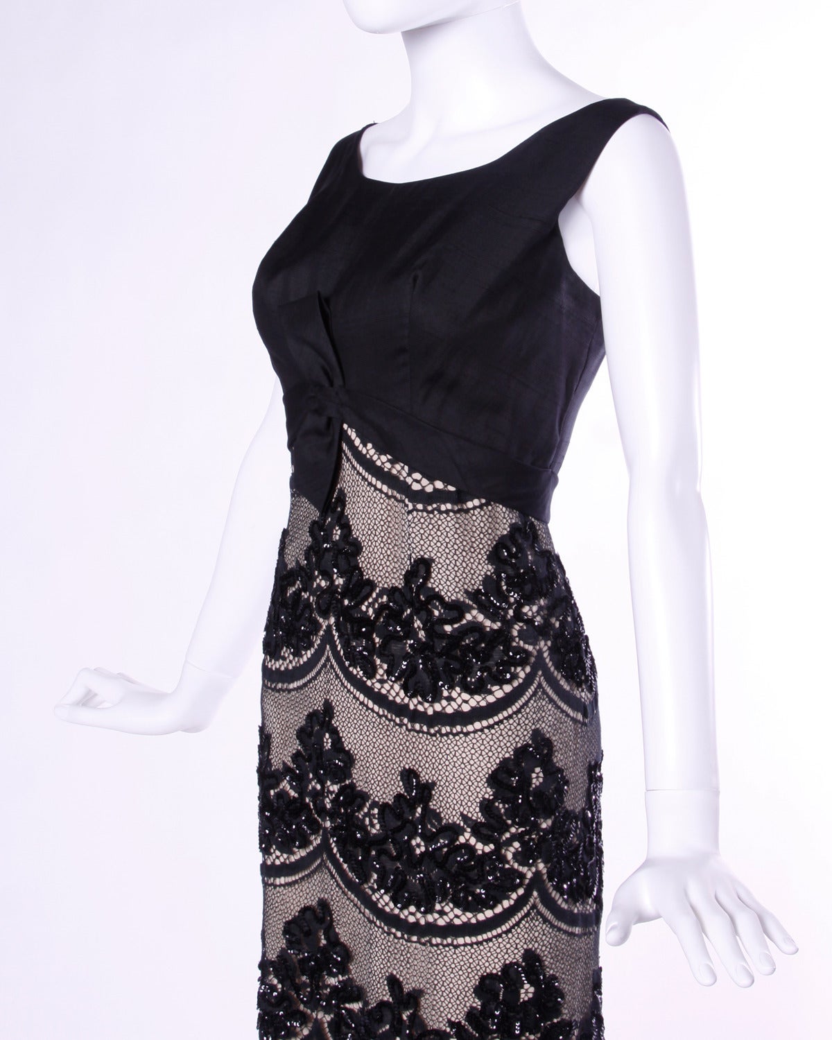 Vintage Emma Domb cocktail dress in black scalloped lace with beadwork. Empire waist with bow detail in front.

Details:

Fully Lined
Back Zip and Hook Closure
Marked Size: 14
Estimated Size: S-M
Color: Black/ Creamy Beige
Fabric: Beaded