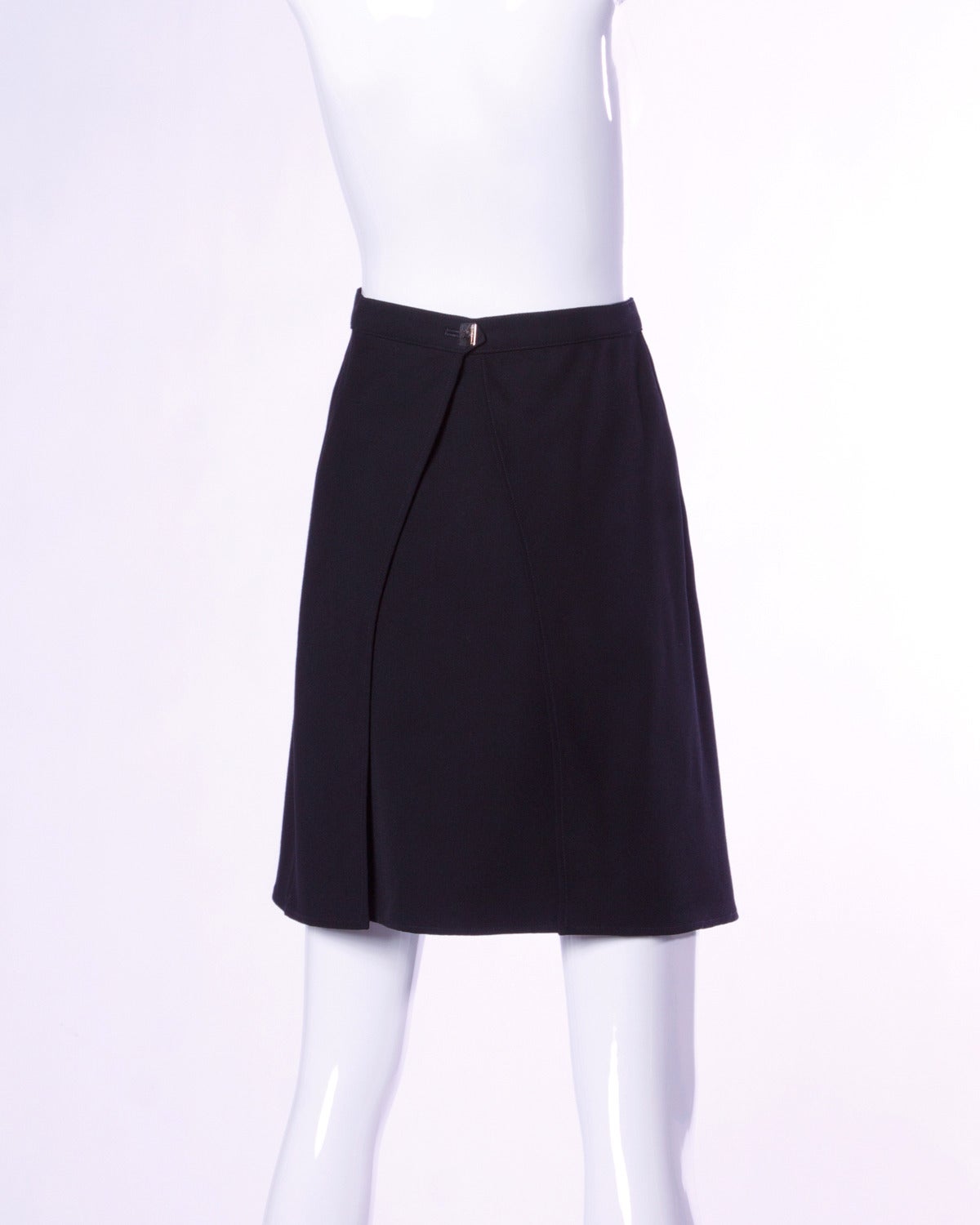 Simple and chic black wool skirt by Karl Lagerfeld with back flap detail and Lagerfeld button. 

Details:

Unlined
Side Snap and Back Button Closure
Marked Size: 40
Color: Black
Fabric: Wool
Label: Karl Lagerfeld

Measurements:

Waist: