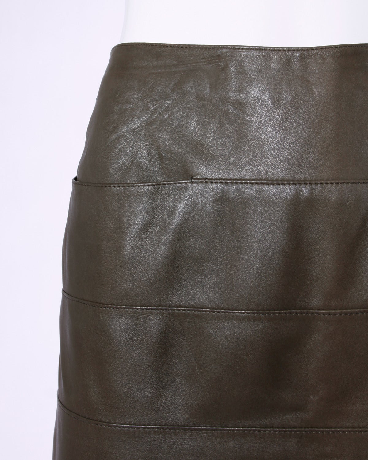 Soft buttery sheepskin leather skirt in olive green by Krizia. Horizontal stitching and hidden slit pockets.

Details:

Fully Lined
Side Zip Closure
Marked Size: 40
Color: Olive Green
Fabric: Sheepskin Leather/ Rayon Lining
Label: