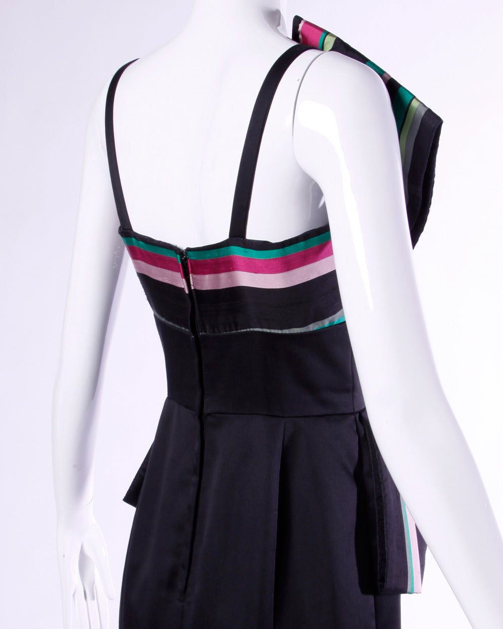 Unique avant garde gown by Victor Costa featuring a colorful striped peplum and architectural shape. 

Details:

Fully Lined
Back Zip and Hook Closure
Marked Size: 6
Estimated Size: Small
Color: Lime Green/ Pink/ Black
Fabric: Not