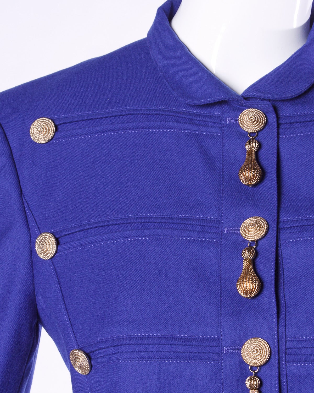Louis Feraud military-inspired jacket with gold-tone hardware and teardrop "tassel" charms.

Details:

Fully Lined
Front Snap & Button Closure
Marked Size: US 6/ UK 10/ F 38/ D 36
Color: Indigo
Fabric: Wool/ Viscose