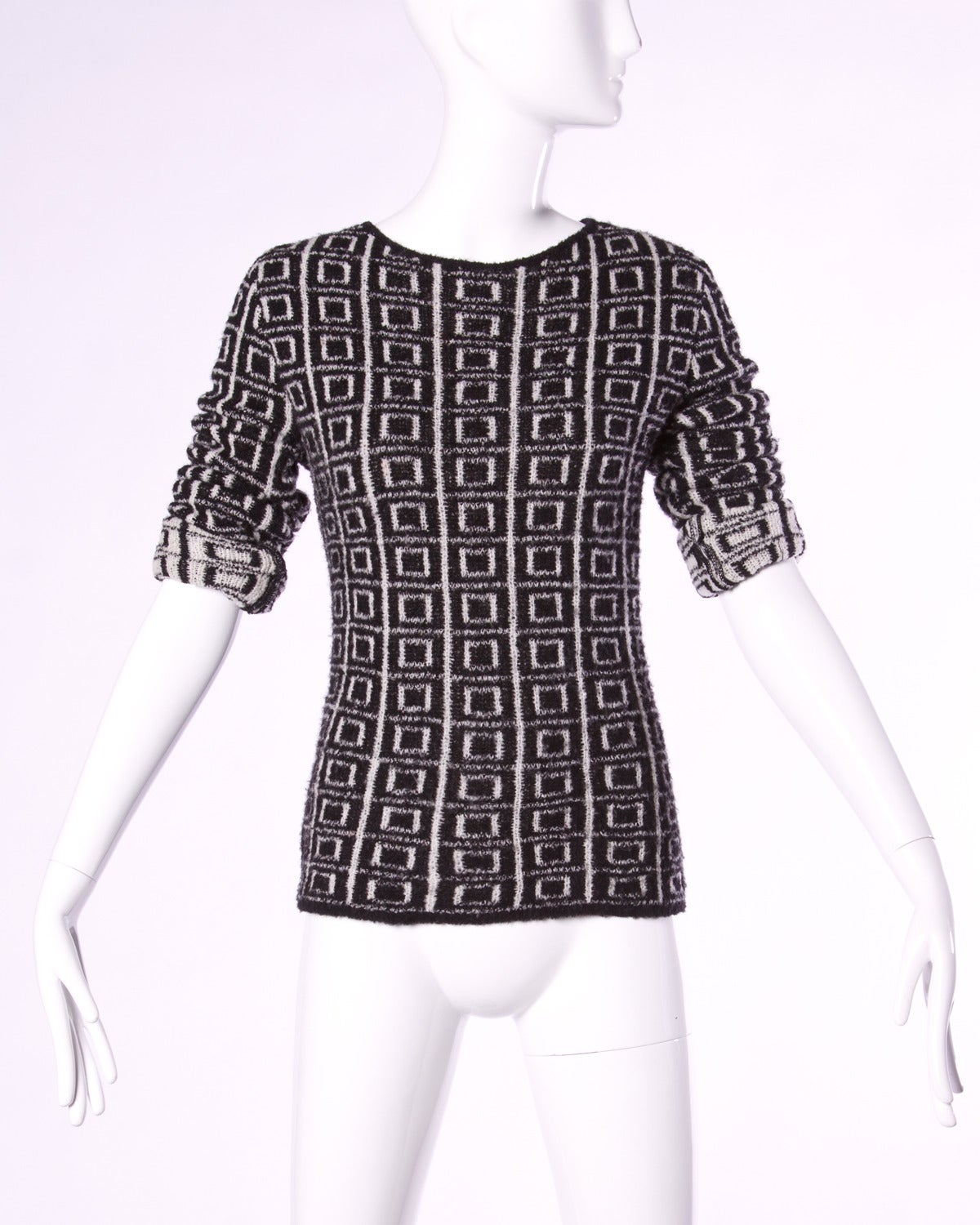 Vintage Krizia sweater with an allover black and white geometric square design.

Details:

Unlined
No Closure/ Fabric Contains Stretch
Color: Black/ White
Fabric: Wool Blend
Label: Krizia

Measurements:

Bust: 36"-44"/ Fabric