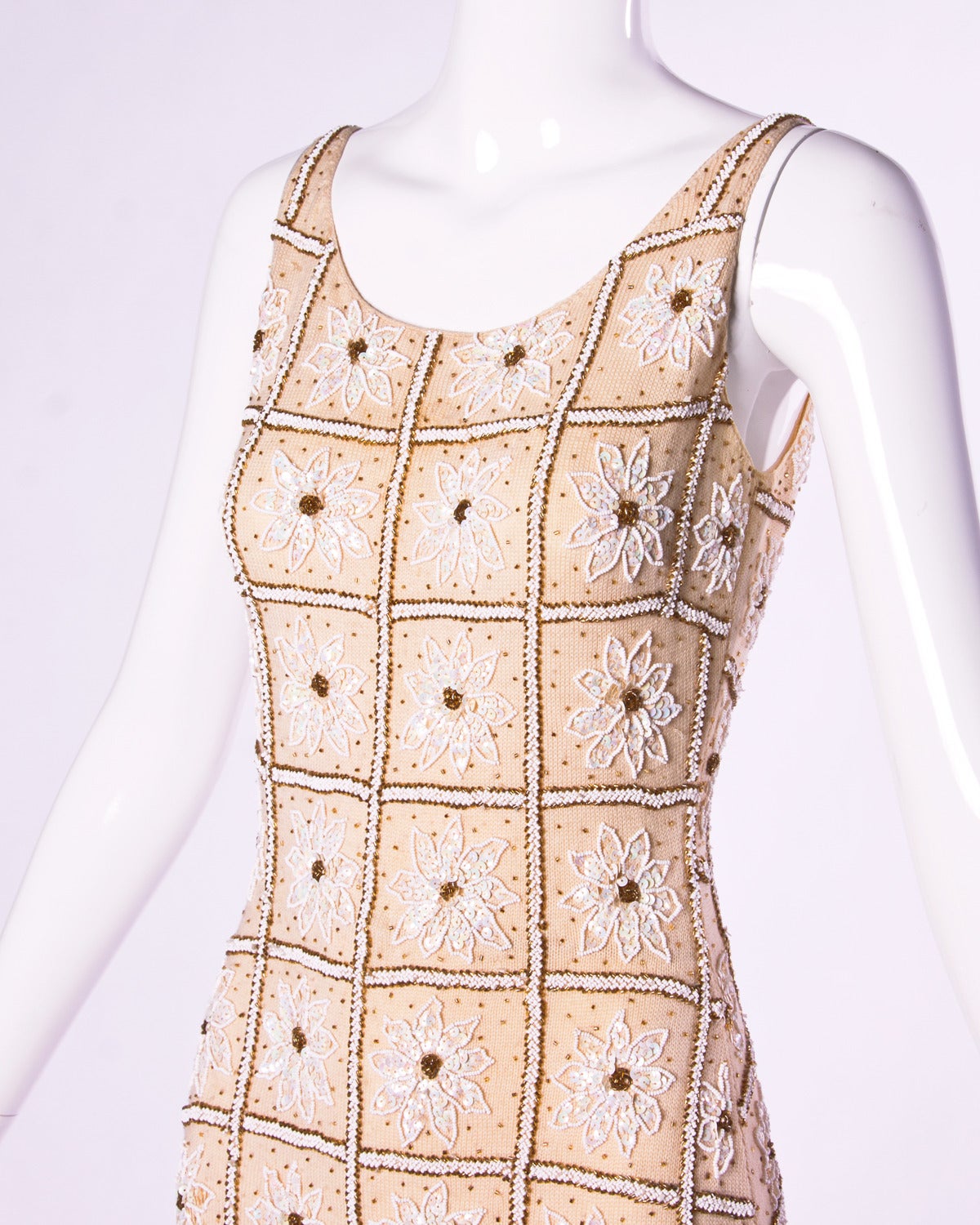 Gorgeous and heavy hand-beaded and sequin wool knit dress. Unlined. Back metal zip and hook closure. Fabric contains some stretch.

Details:

Unlined
Back Metal Zip Closure
Circa: 1960s
Estimated Size: XS
Color: Nude / White /