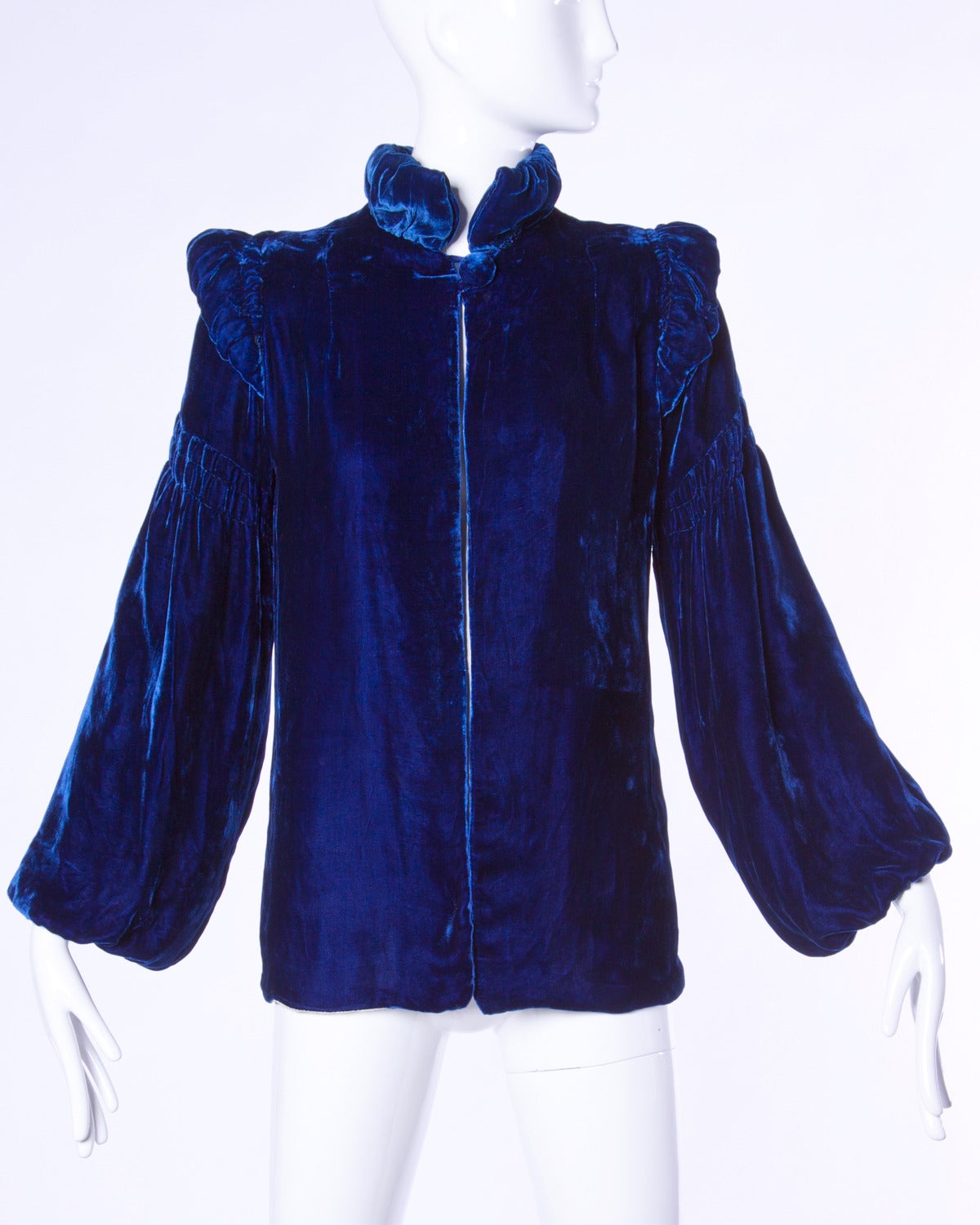 Gorgeous deep blue silk velvet opera jacket with ruched shoulders and balloon sleeves.

Details:

Fully Lined
Front Button Closure
Color: Blue
Fabric: Velvet

Measurements:

Bust: Up To 40
