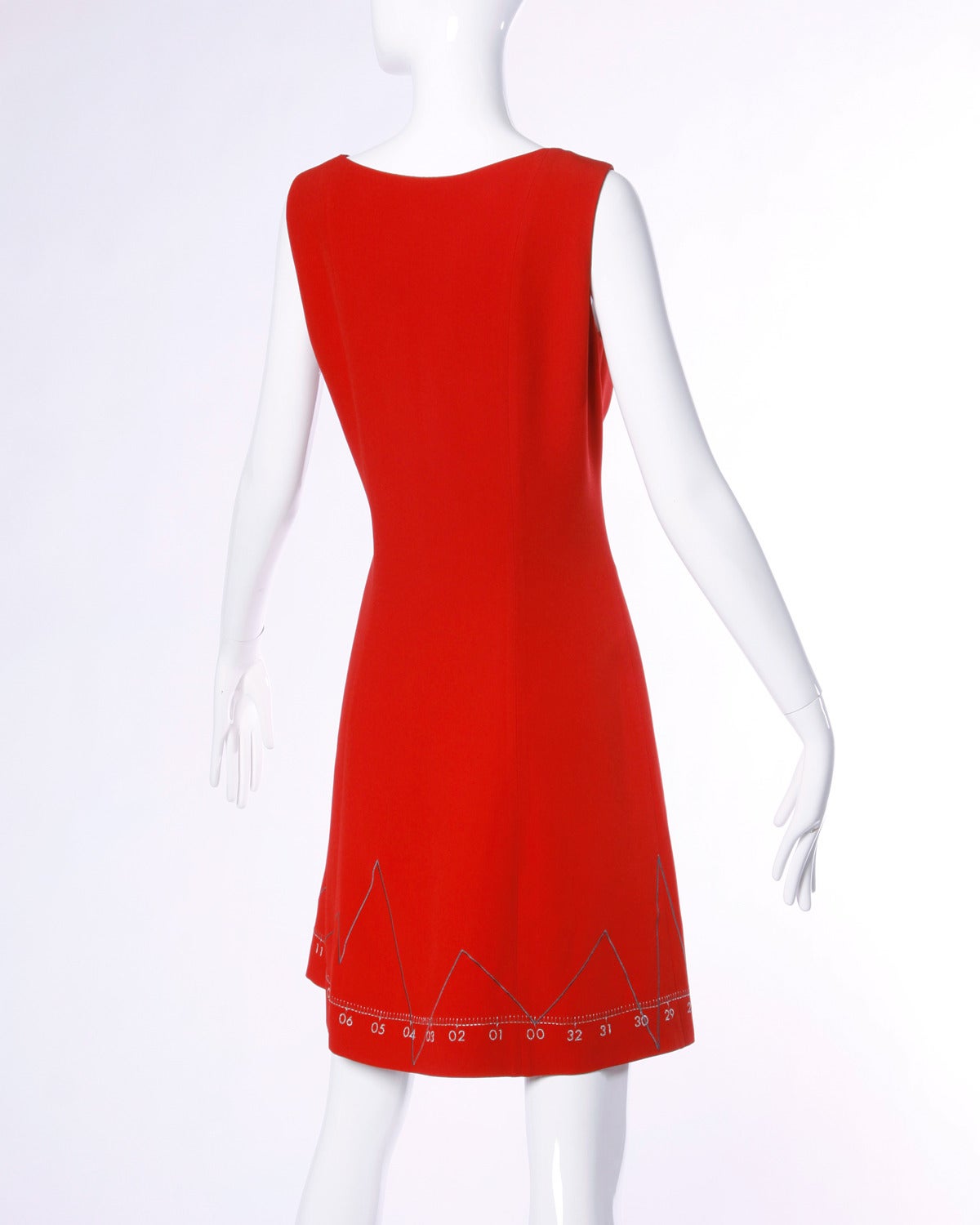 Reduced from $850. Iconic vintage Moschino red dress with embroidered love charts and graphs. The dress features numbers along the bottom and the lower graph forms the shape of a heart.

Details:

Fully Lined
Side Zip Closure
Marked Size: US