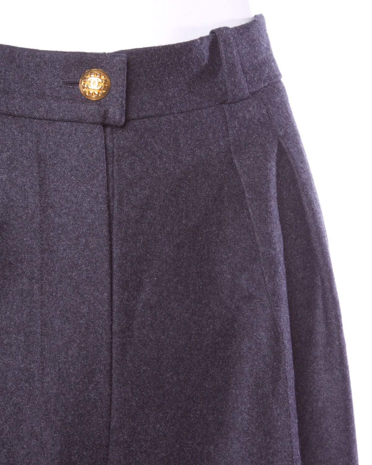 Stunning vintage Chanel soft gray wool high waisted trousers with gold tone CC logo buttons. Well tailored, simple and elegant.

Details:

Fully Lined
Back Pockets
Front Button and Hook Closure
Marked Size: 36
Color: Charcoal Gray
Fabric: