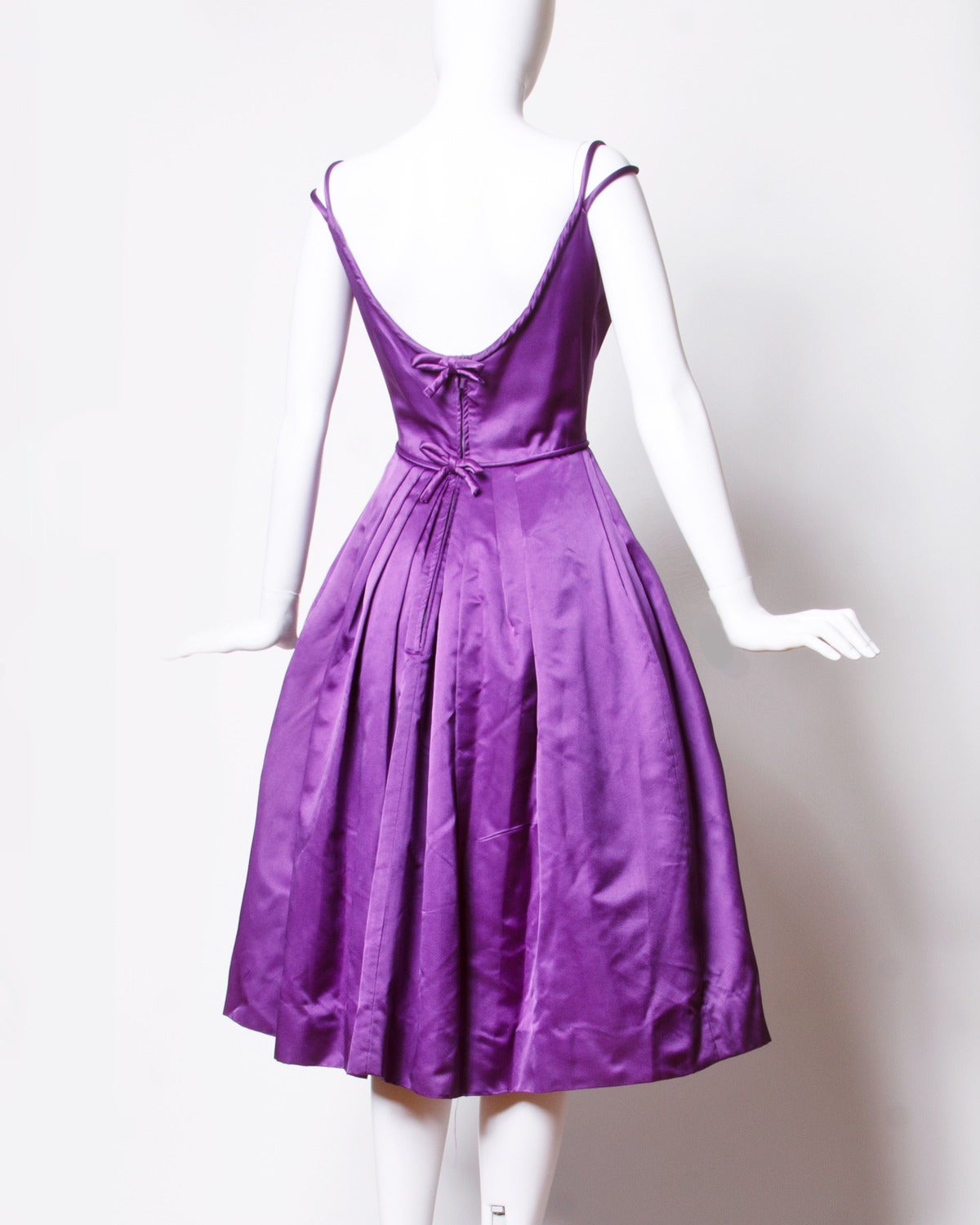 Gorgeous purple satin formal dress by Mollie Stone for Minuet. Double strap detail and bows up the back of the dress.

Details:

Fully Lined
Back Metal Zip Snap and Hook Closure
Marked Size: Not Marked
Estimated Size: XS
Color: