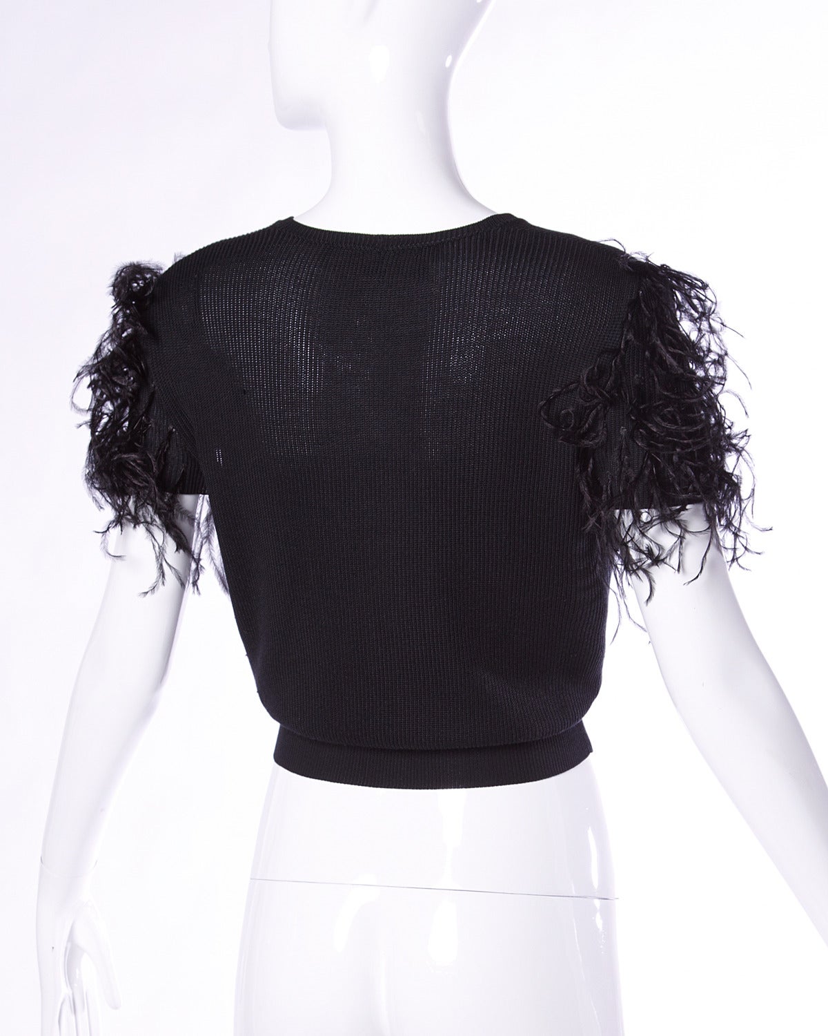 Vintage black silk knit top with a deep V neckline and feather sleeves by Valentino.

Details:

Unlined
No Closure/ Fabric Contains Stretch
Marked Size: Small
Color: Black
Fabric: Silk
Label: Valentino Boutique

Measurements:

Bust: Up