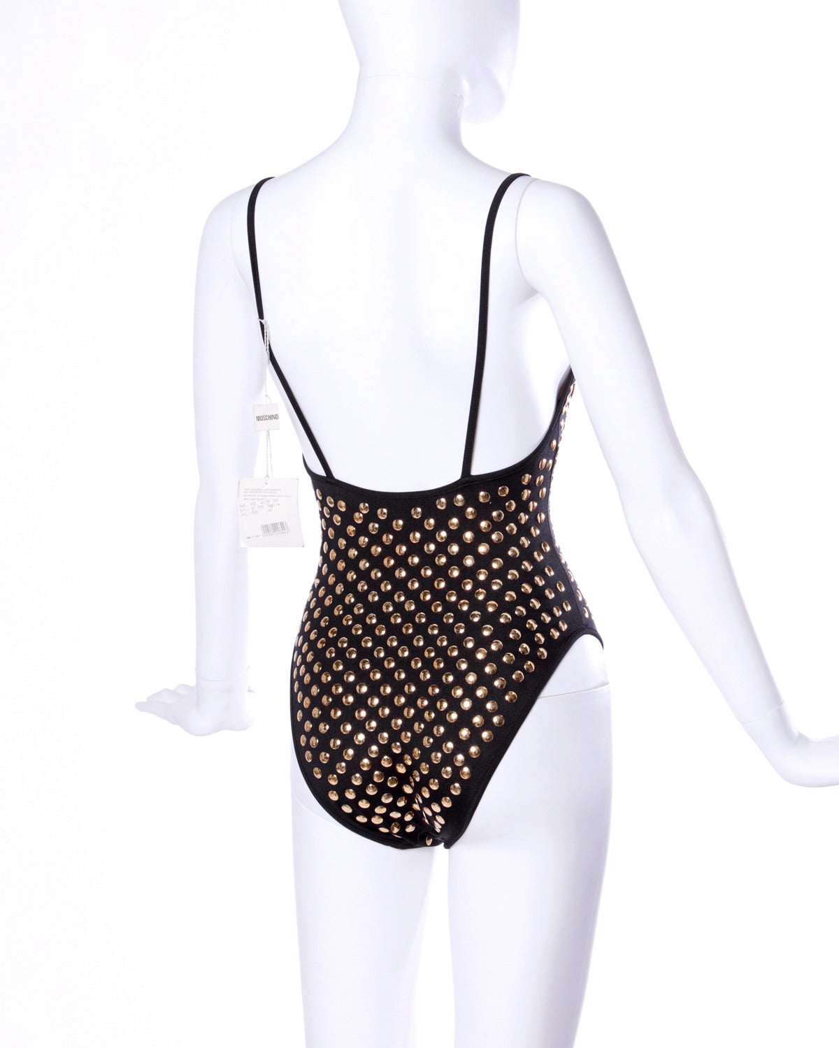 Unworn with the original tags still attached! Vintage Moschino Mare swim suit or body suit with gold studs. 

Details:

Partially Lined
No Closure/ Fabric Contains Stretch
Estimated Size: XS
Color: Black/ Gold
Label: Moschino