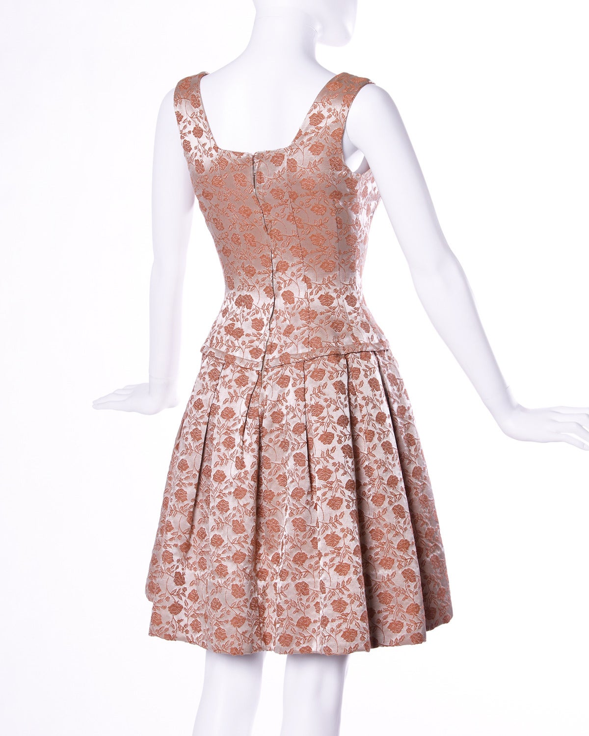 Vintage floral brocade cocktail dress with a drop waist.

Details:

Unlined
Back Metal Zip and Hook Closure
Marked Size: Not Marked
Color: Dark Rosy Peach
Fabric: Brocade

Measurements:

Bust: 32