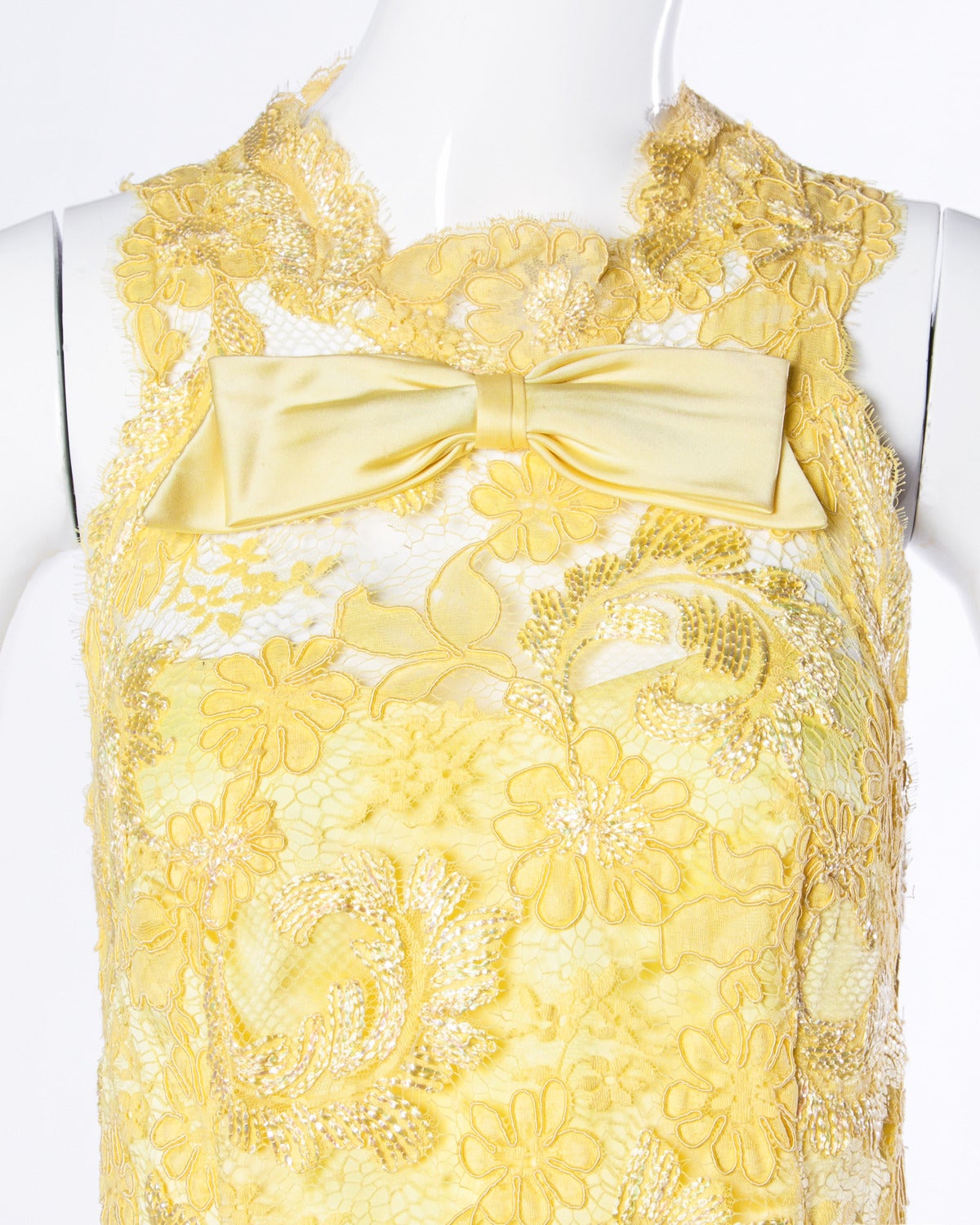 Gorgeous custom yellow lace shift dress with a bow detail and metallic thread accents. This dress is extremely well made and features couture hand stitching throughout the dress. The lace work is just stunning!

Details:

Partially Lined
Back