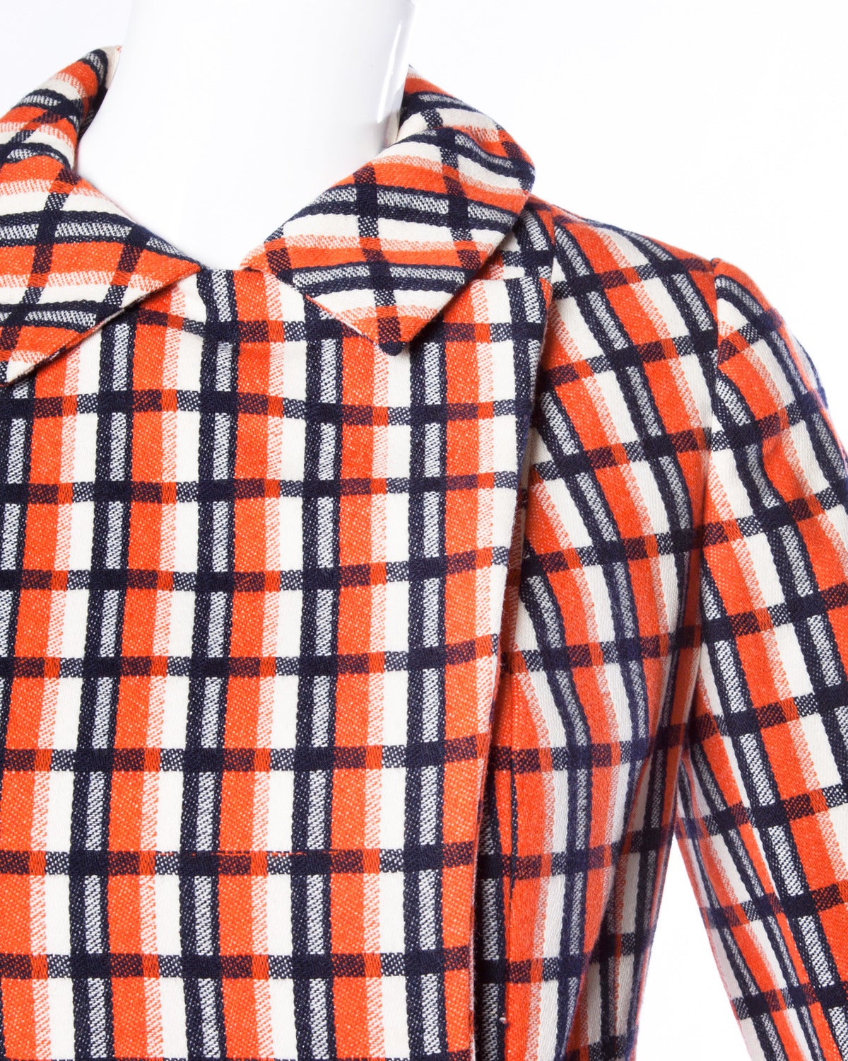 Vibrant plaid jacket and skirt set by Bill Blass for Maurice Rentner. Gold buttons and chain detail. Pleated skirt.

Details:

Fully Lined
Front Snap Closure On Jacket/ Side Hook and Zip Closure On Skirt
Estimated Size: XS
Color: Orange/