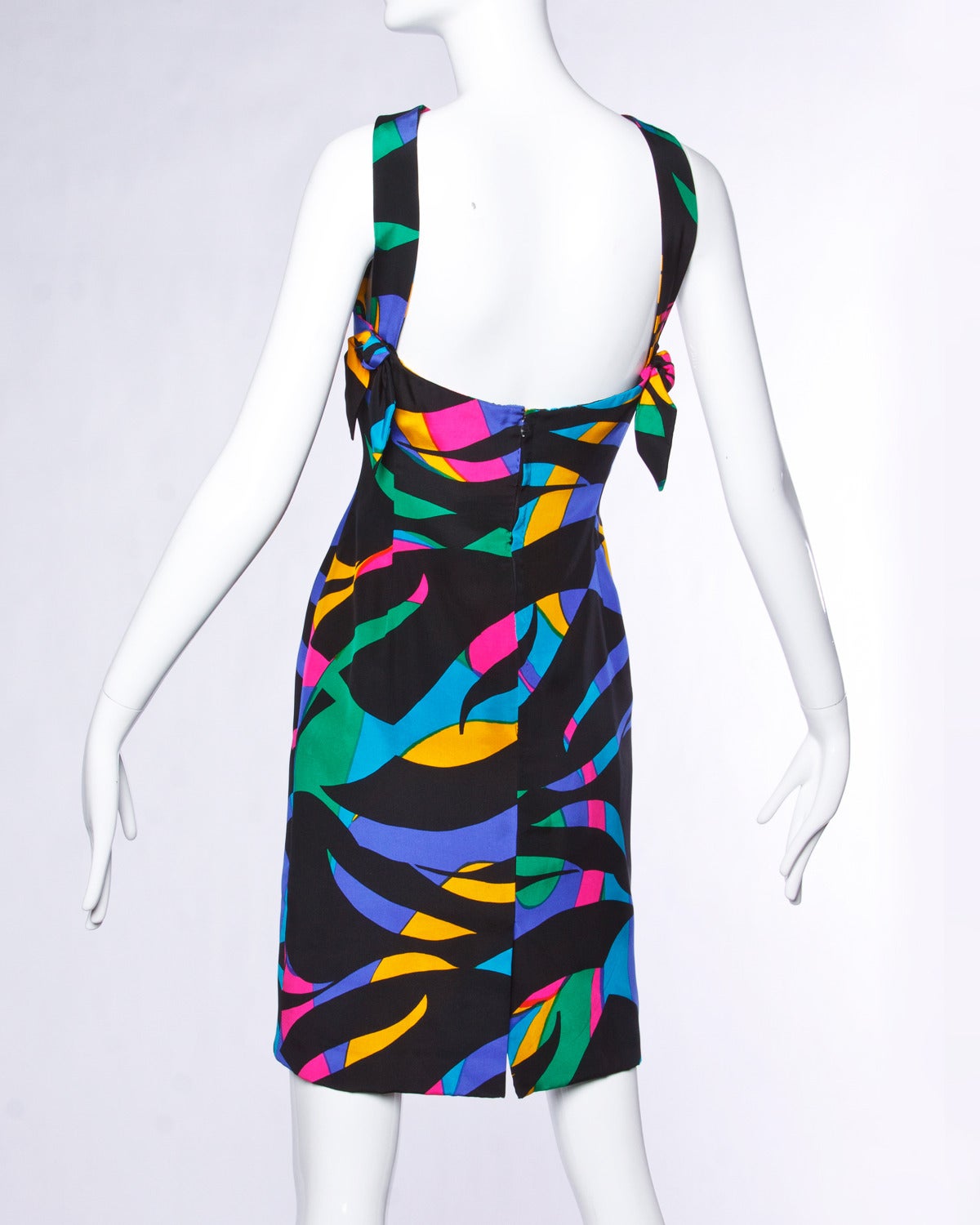 Gorgeous colorful printed silk sheath dress by Michael Novarese. Halter neckline with keyhole detail. Fully lined in silk with hand sewn couture stitching. Bows at the back of the straps. 

Details: 

Fully lined
Back Zip Closure
Colors: