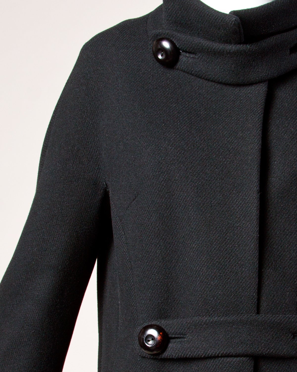 Stunning tailored heavy black wool mod coat by Louis Feraud. Amazing 1960s cut with oversized buttons and vintage silhouette. Fully lined in black satin.

Details:

Fully Lined
Hidden Side Pockets
Front Button and Snap Closure
Estimated Size: