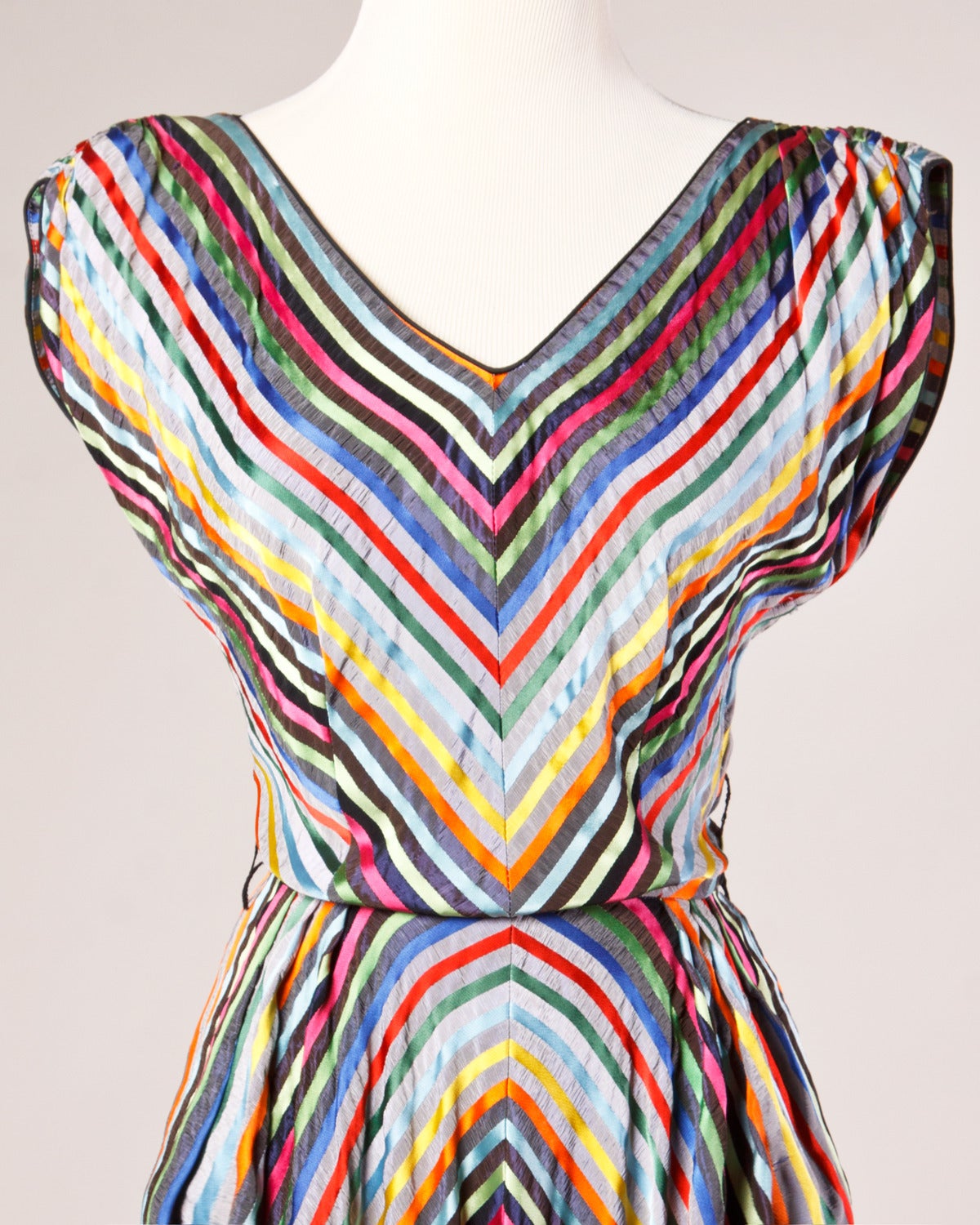 Gorgeous vintage party dress in colorful rainbow stripes. Full sweep with gathered shoulders and a V-neckline. 

Details:

Side Metal Zip Closure
Unlined
Multicolor Rainbow Striped Fabric
Full Sweep
Estimated Size