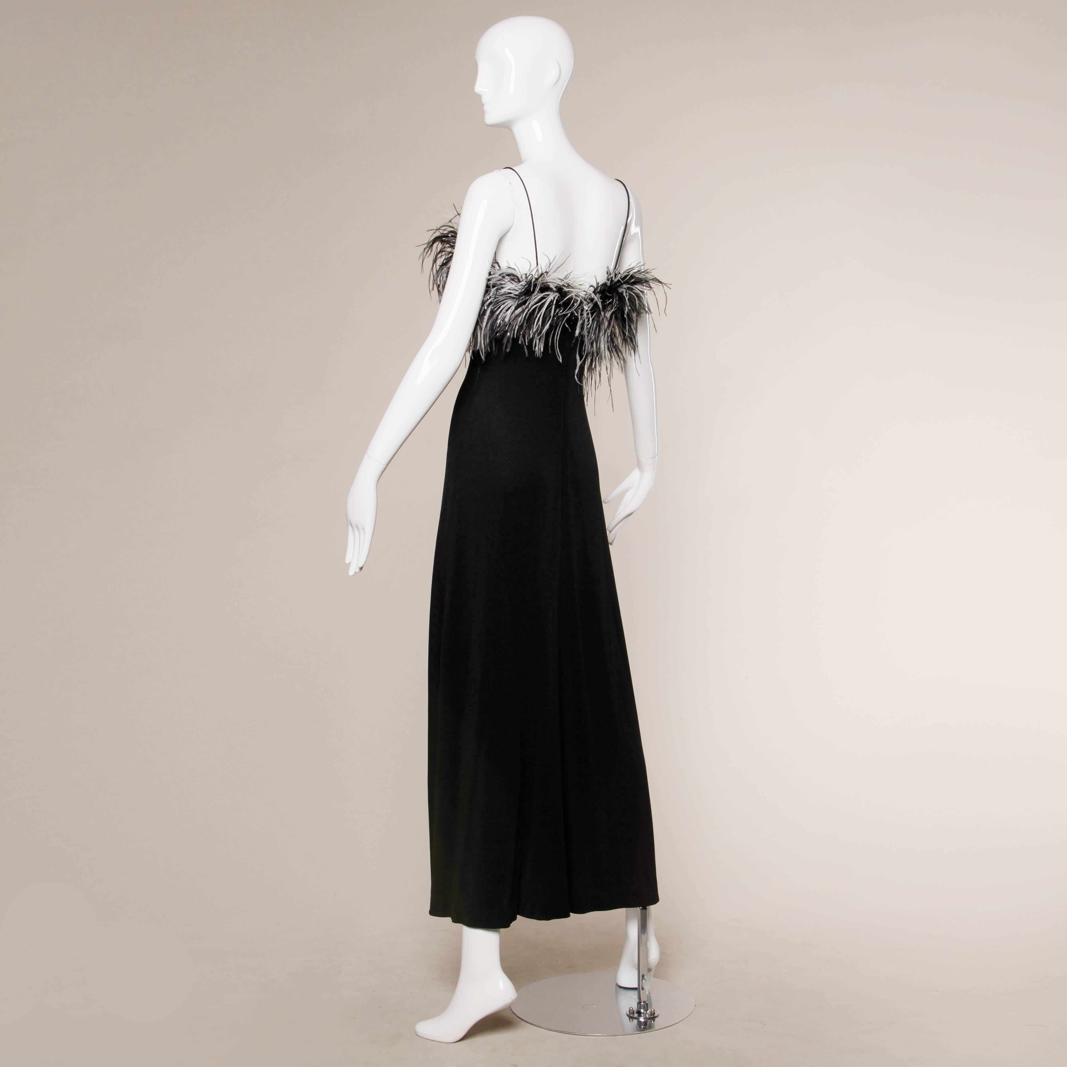 Slinky black jersey knit maxi dress with metallic flecked ostrich feather trim. Spaghetti straps. Unlined. No closure, pulls on. Fabric contains quite a bit of stretch. The measurements of the dress are as follows:

Bust: 34