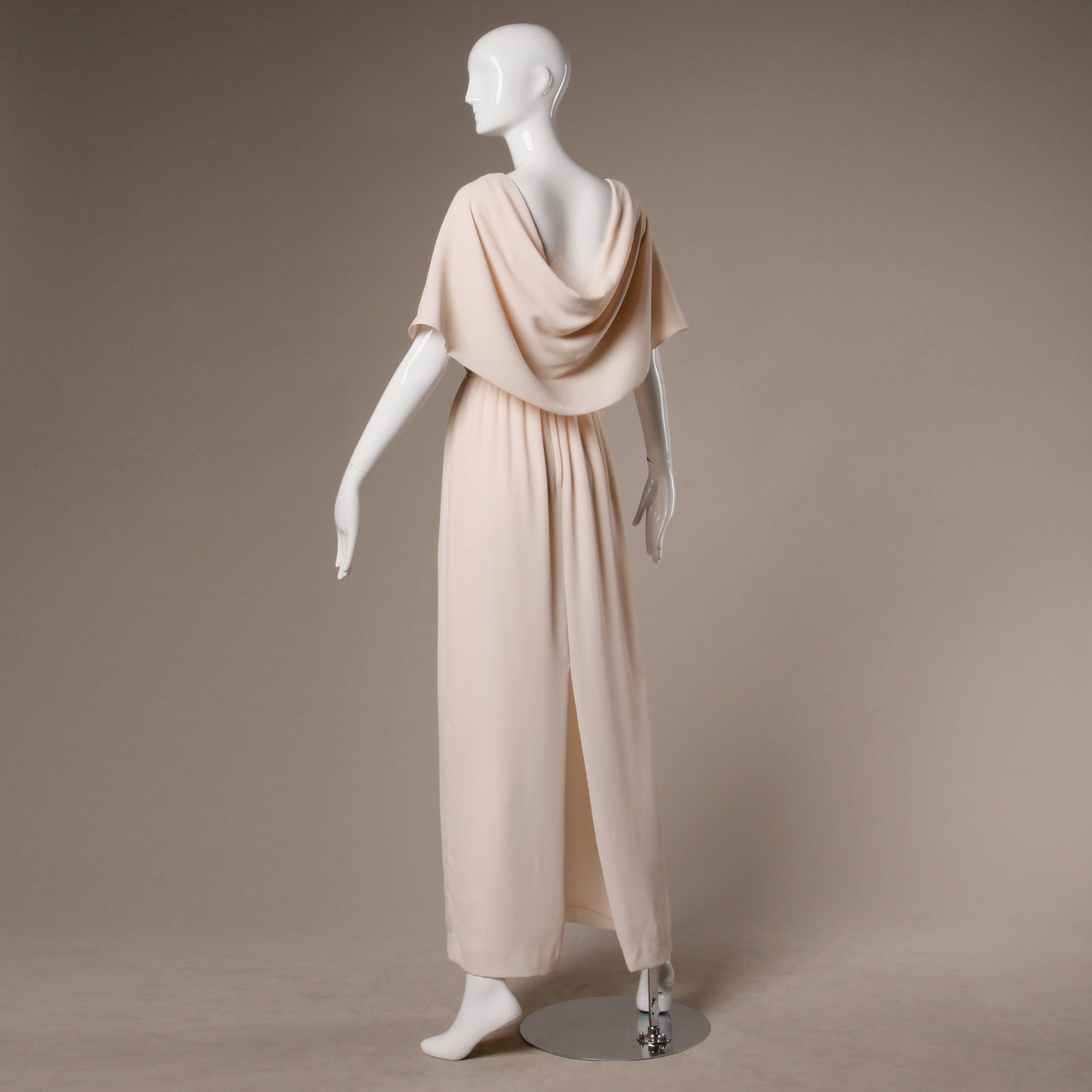 Elegant vintage Jack Bryan blush gown with the original tags still attached. Matching ruched sash waistband. Rear zip and hook closure. Fully lined. 100% light weight polyester. The marked size is 8. The dress fits like a modern small-medium. The