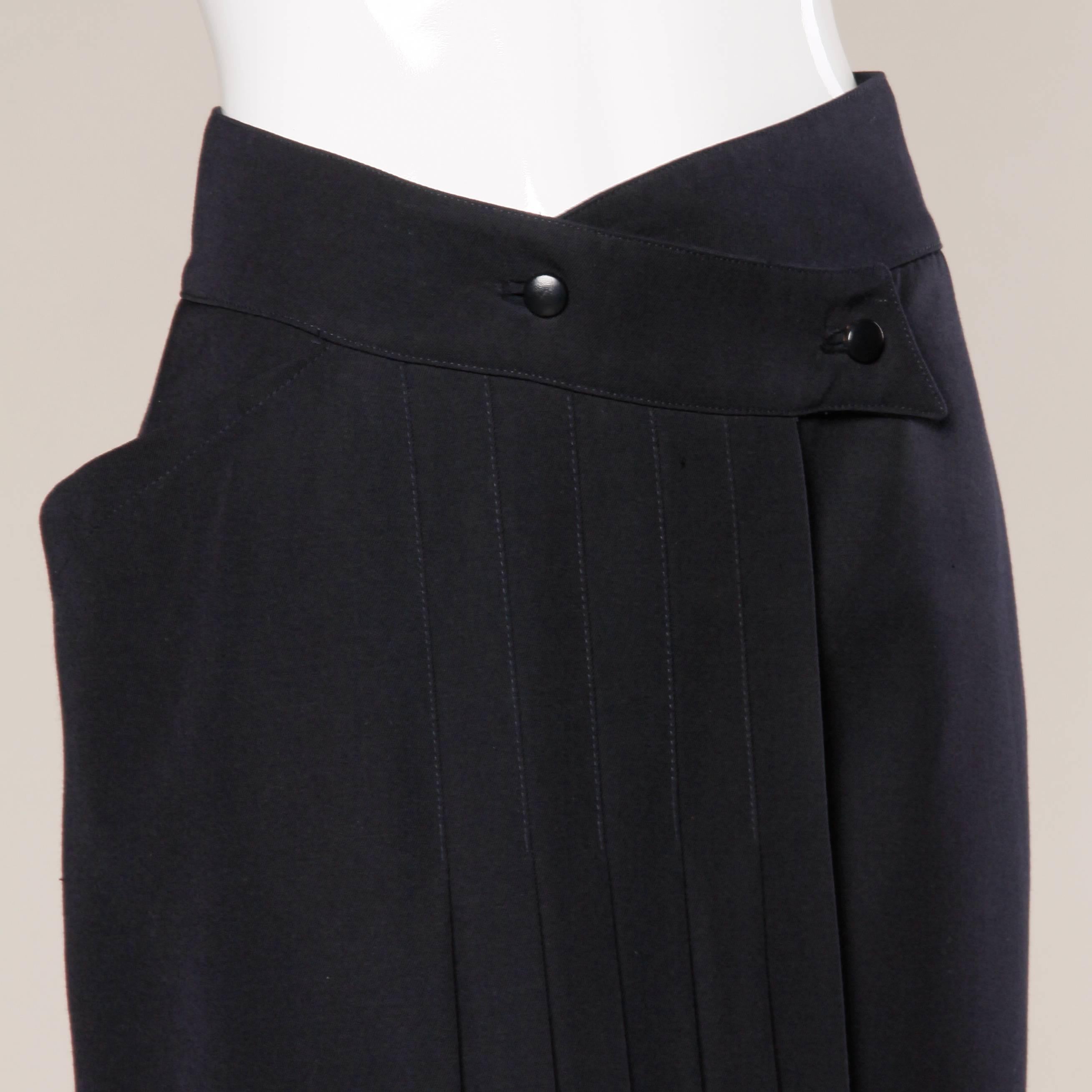 Gorgeous vintage navy blue wool avant garde skirt by Claude Montana. Unique cut with pleating and one side pocket. Fully lined with front button closure. The marked size is a US 6. The skirt fits true to the marked size. The measurements are as