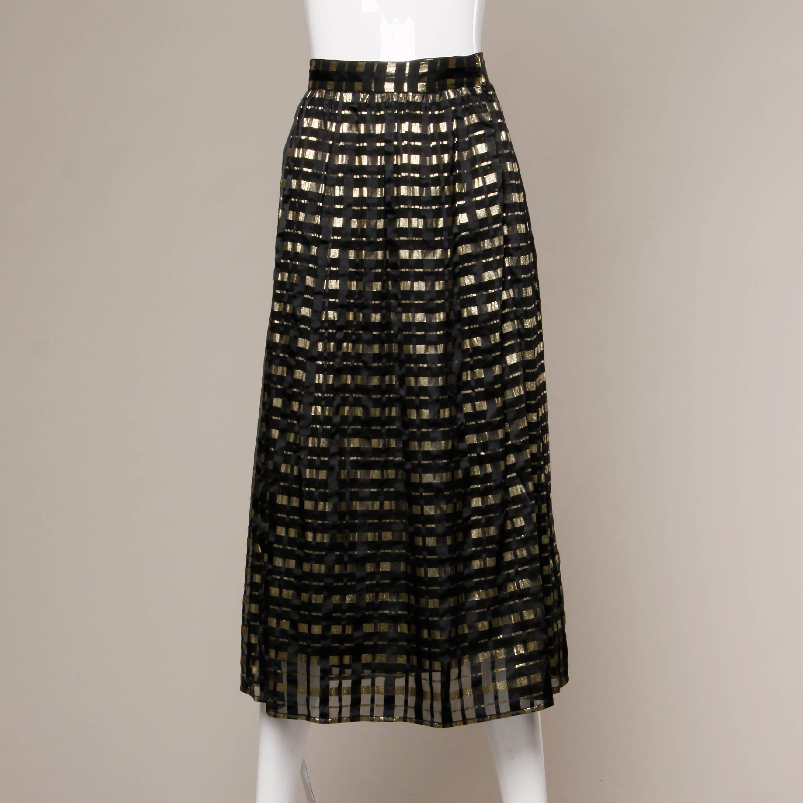Gorgeous paper thin metallic gold and black silk chiffon ensemble. The blouse is unlined and is completely sheer. The skirt is pleated and lined in black silk. The measurements are as follows:

Blouse Measurements

    Bust: 39