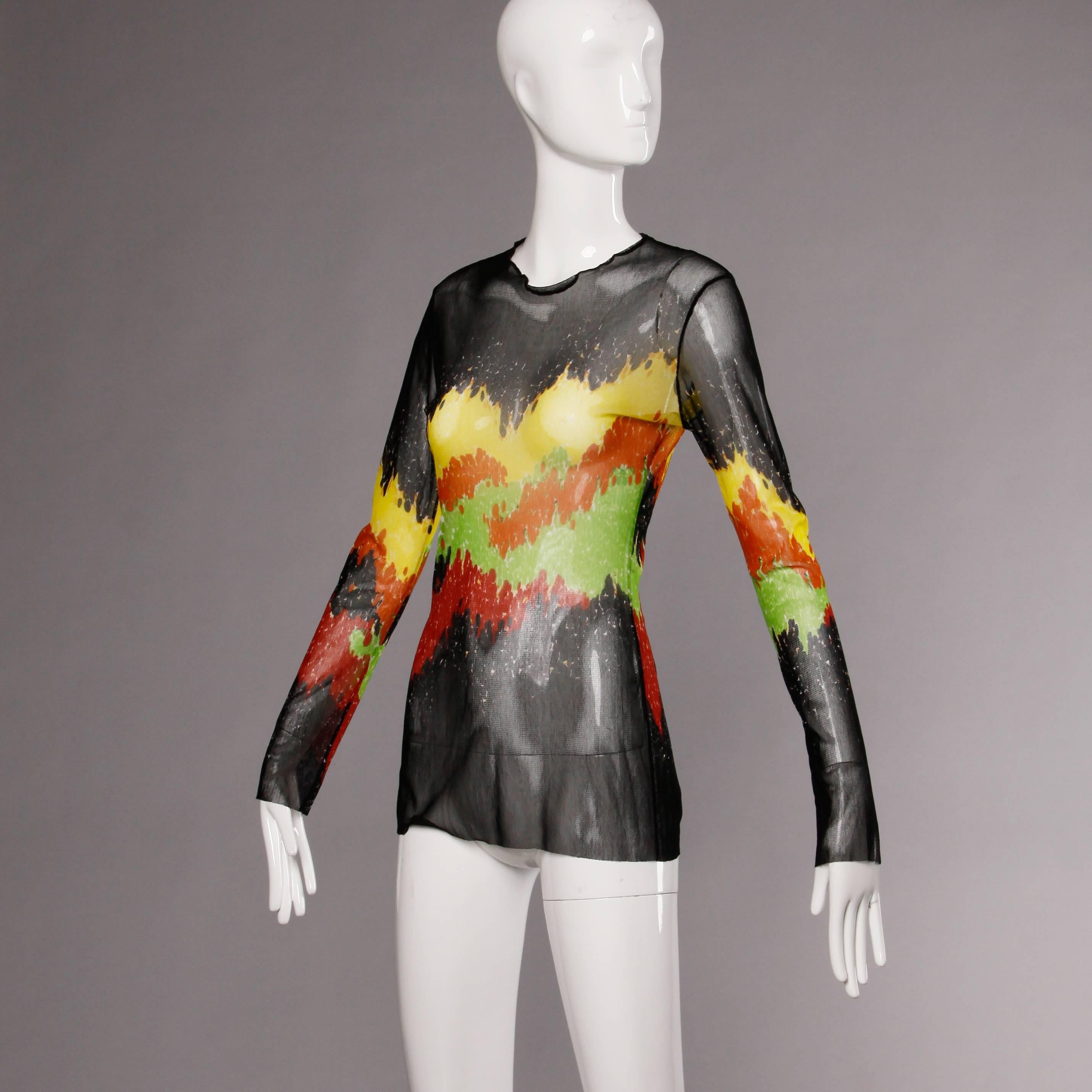 Sheer mesh Jean Paul Gaultier Maille long sleeve top in a multicolor abstract print. The marked size is a US large and the top fits true to size. The measurements are as follows:

Bust: 34-40