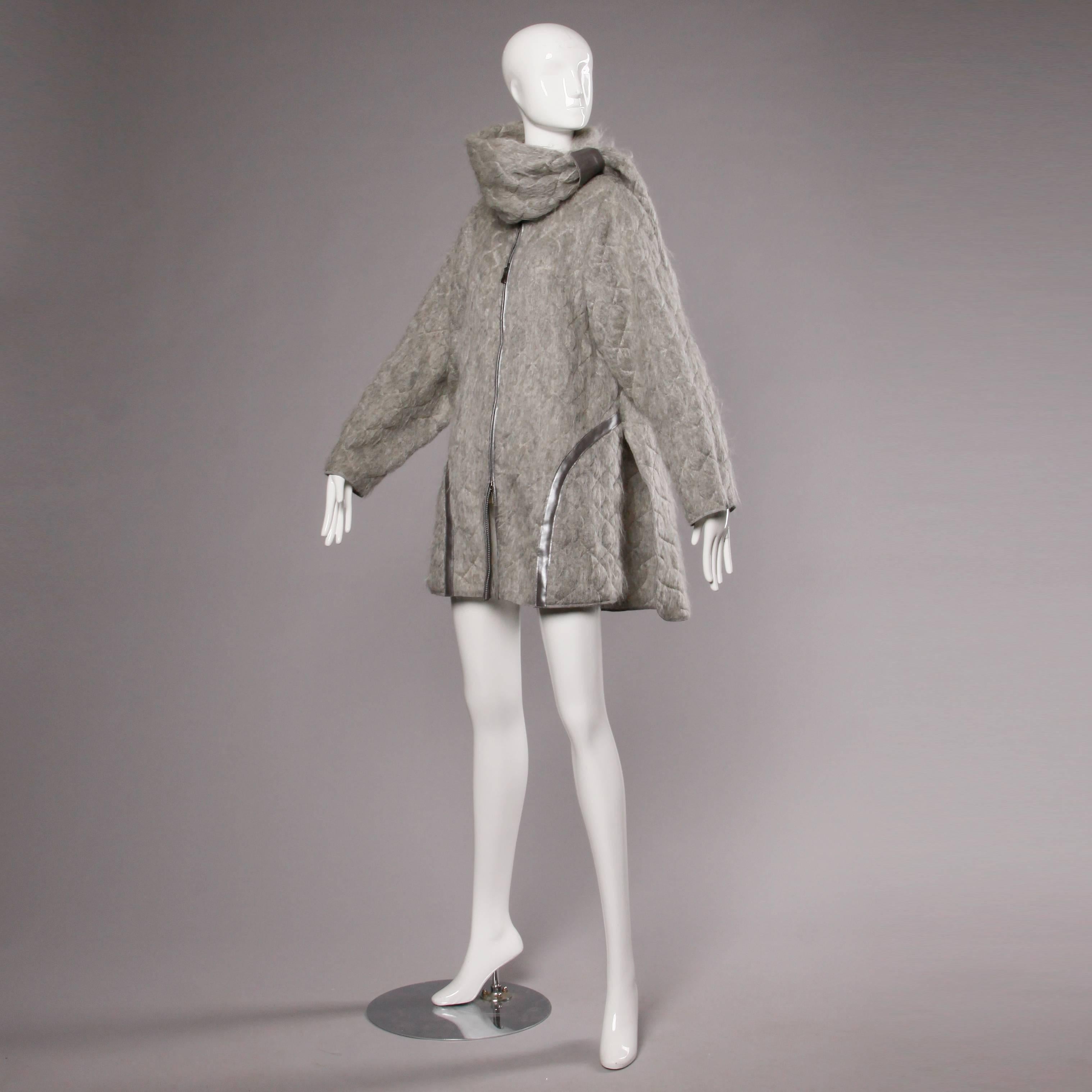Amazing vintage oversized cocoon coat by Claude Montana with an asymmetric attached scarf. Unlined. Front two way zip closure. Silver leather trim. 70% mohair 30% wool. Marked size 44. Estimated size free. The measurements are as follows:

Bust: