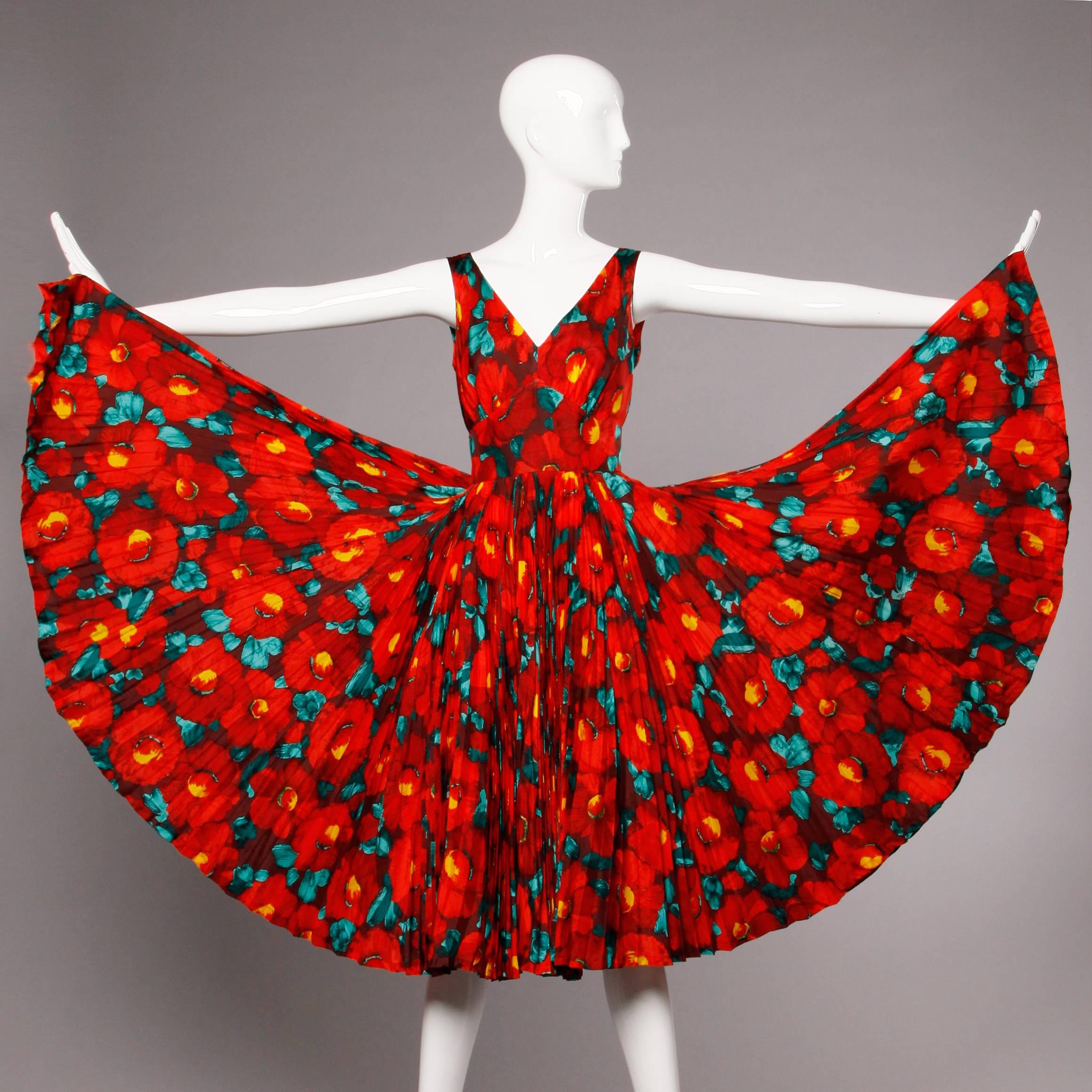 This dress is incredible! The silk fabric is gorgeous with a vibrant red floral print. The skirt is full and features a lot of pleated fabric and a 360 degree sweep. Fully lined. Fabric content is not marked but it feels like 100% silk. Rear metal