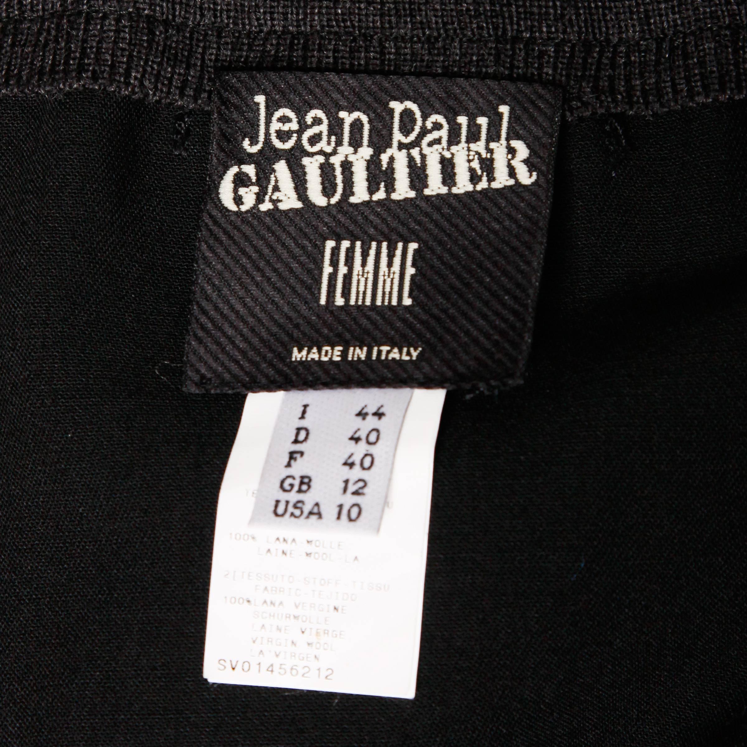 Black wool avant garde skirt by Jean Paul Gaultier. Gray wool trim and two way front zipper. Unique cut with a high low hemline. Made in Italy. Unlined. 100% wool. The marked size is a US 10 / GB 12 / I 44 / D 40 / F 40 and the skirt fits true to