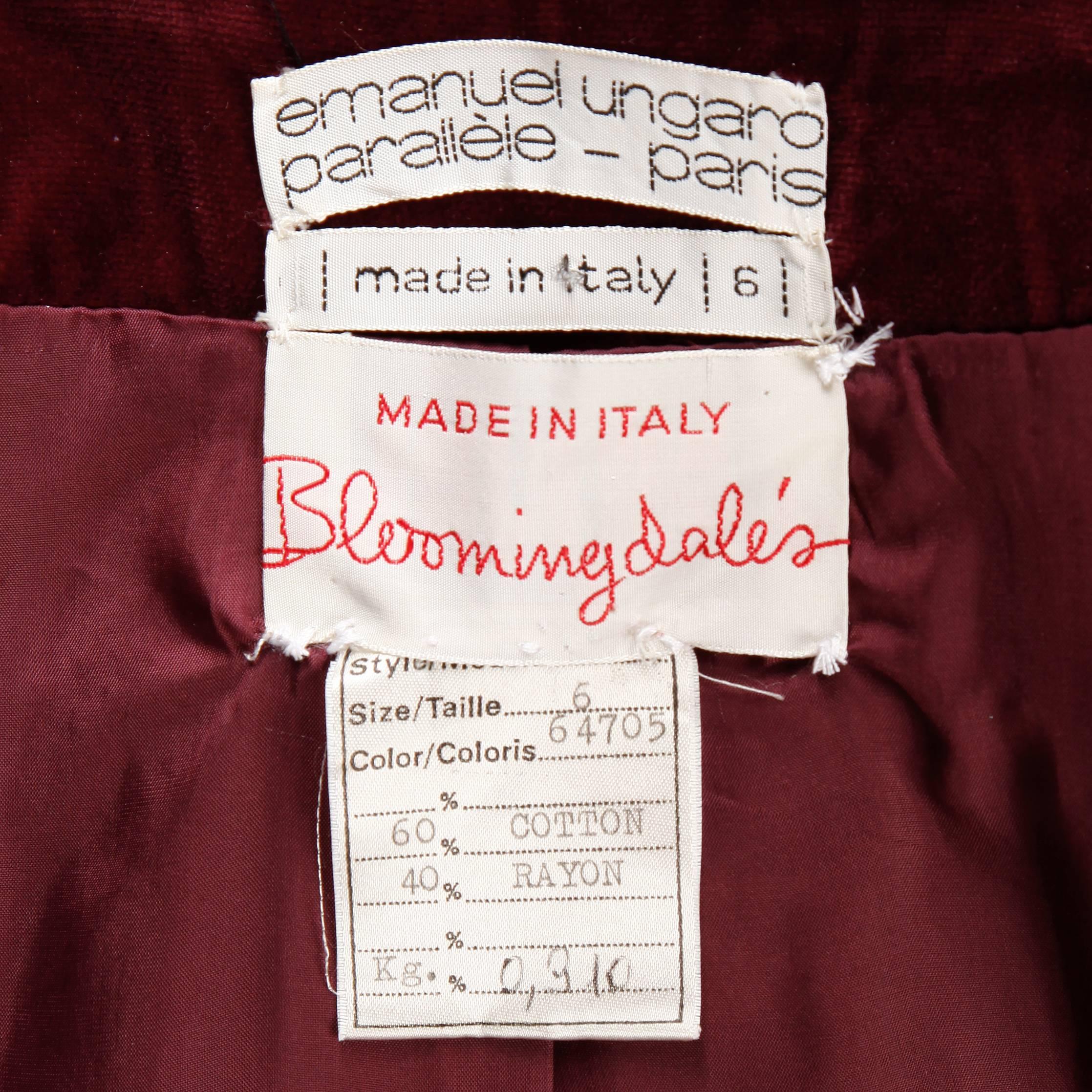 Rare 1970s Emanuel Ungaro Parallele label! Gorgeous burgundy rayon/ cotton blend velvet with matching waist sash and burgundy enamel buttons. Love the structured pointed collar and the full sleeves. Side pockets. Fully lined. The marked size is a US