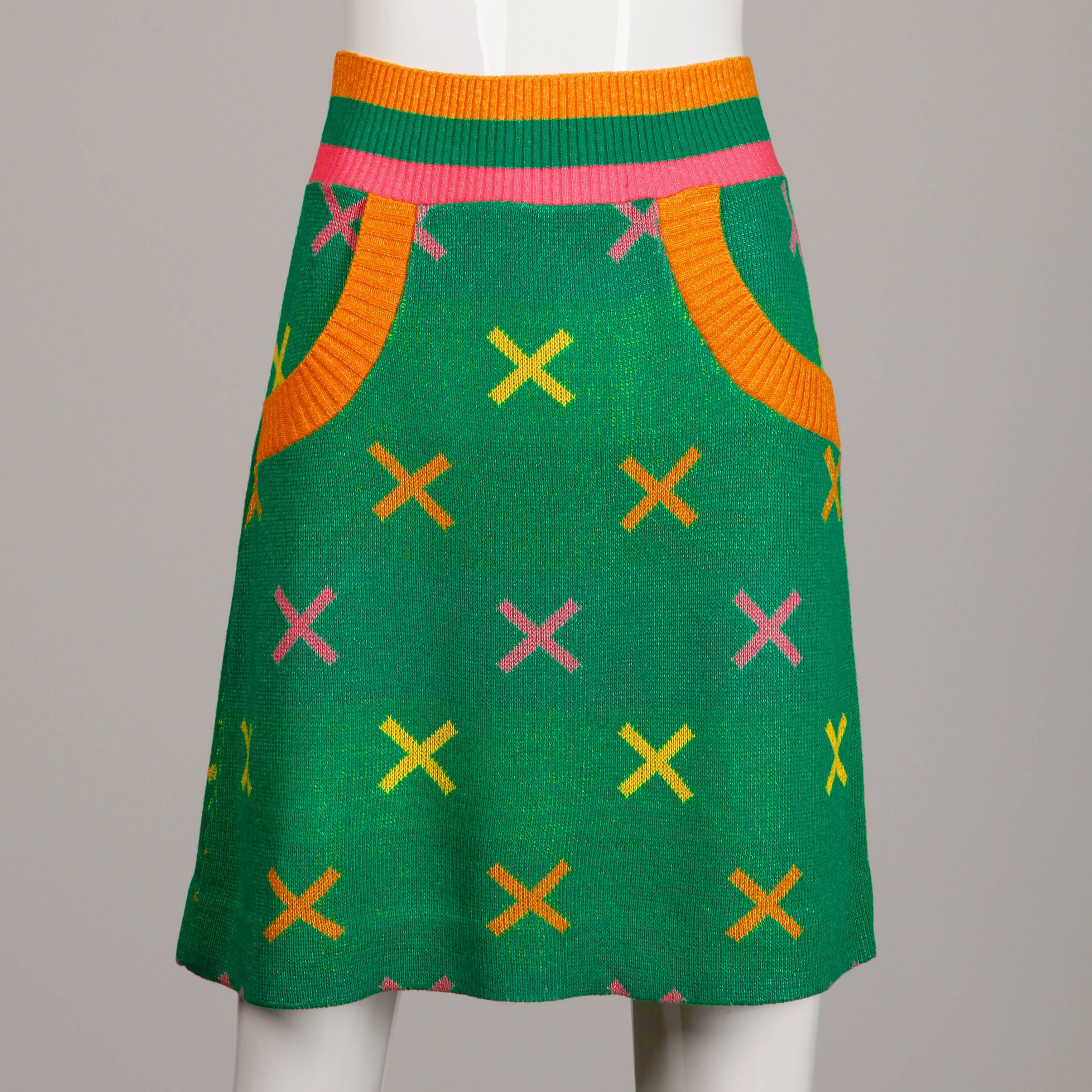 Two-piece knit sweater and skirt set by Giorgio Sant'Angelo from the 1970s featuring a bright colored "X" design. The size on this set is not marked, but it fits like a modern size small. On the top the bust measures 32"-36",